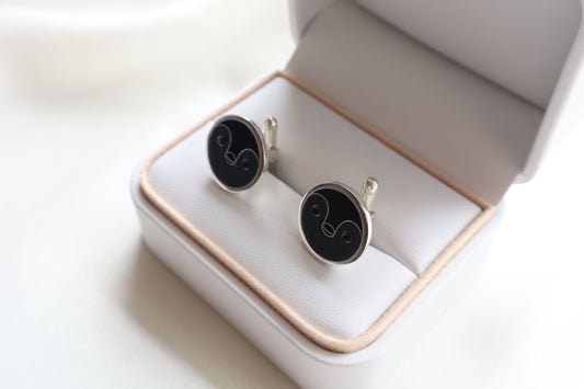 Custom 925 silver cufflinks with matte and glossy enamel and black onyx eyes, designed as a penguin face. A modern jewelry gift in Singapore with refined packaging.
