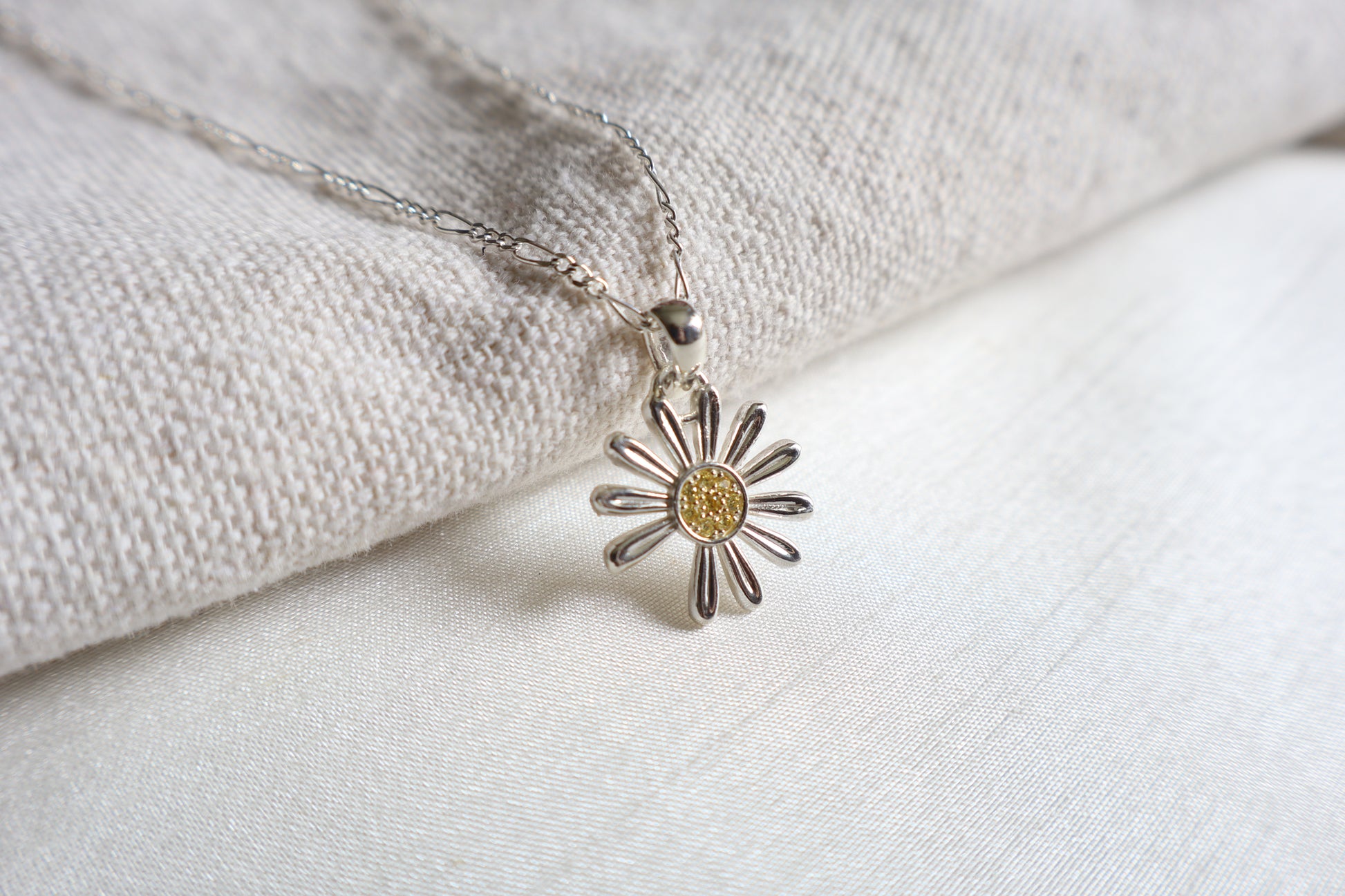 925 Silver K-Pop idol daisy pendant with Yellow Sapphires, showcased in Singapore custom gift packaging for corporate events