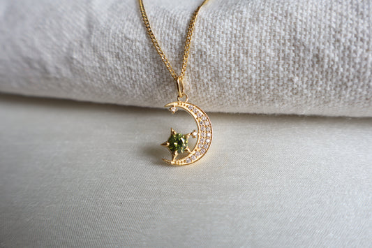 14-Karat Gold crescent moon pendant with peridot star and diamond accents. Designed in Singapore with luxury packaging, perfect for corporate gifts and client milestones.
