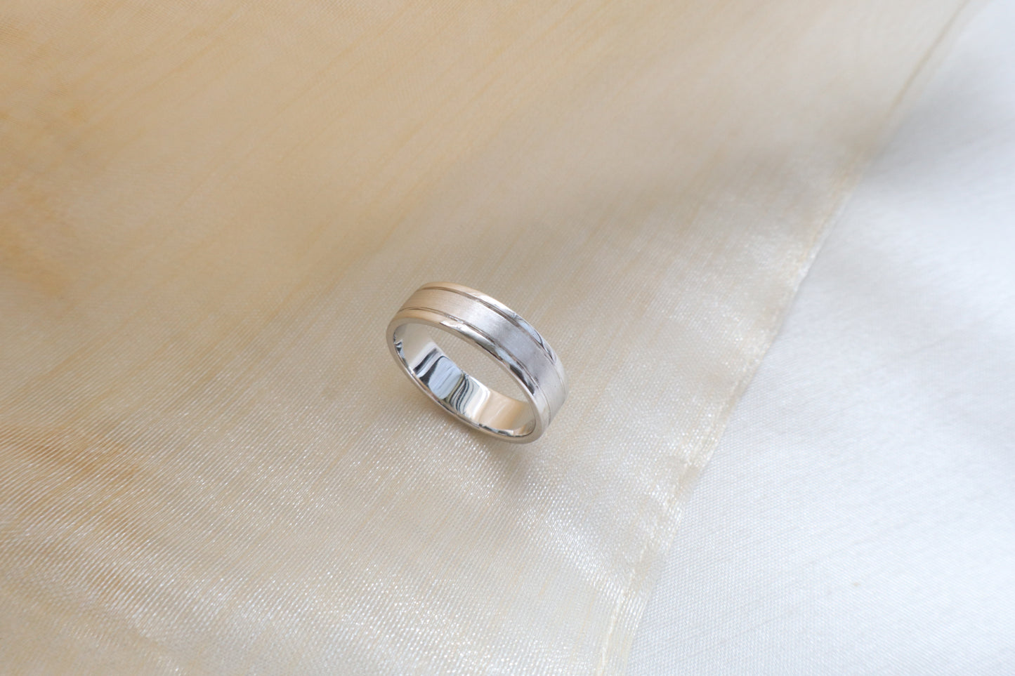 Custom gold bridal ring set with a moissanite engagement ring, diamond wedding band, and engraved groom’s ring, designed as a cohesive family heirloom. Eco-friendly abaca packaging. Singapore corporate jewelry.