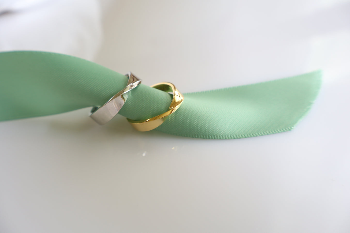 Two-tone silver and gold curved couple rings, minimalist his and hers commitment bands — Corporate service anniversary jewelry — gold pin with logo engraving, Singapore supplier.