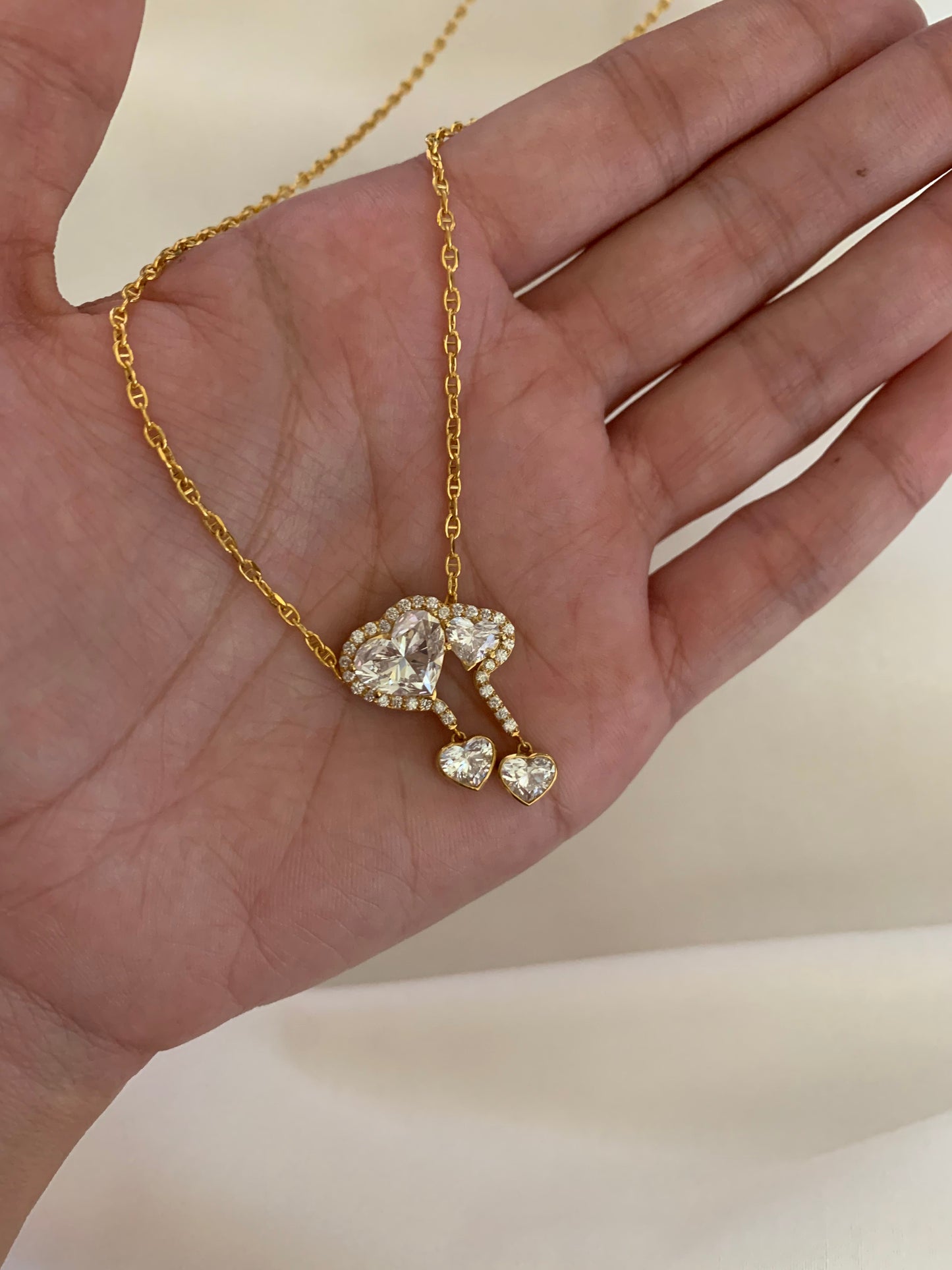 18K gold necklace featuring a 3ct diamond and GIA-certified heart diamonds. Sustainable corporate gift jewelry with abaca packaging. Custom gold-plated necklace, bespoke design in Singapore.