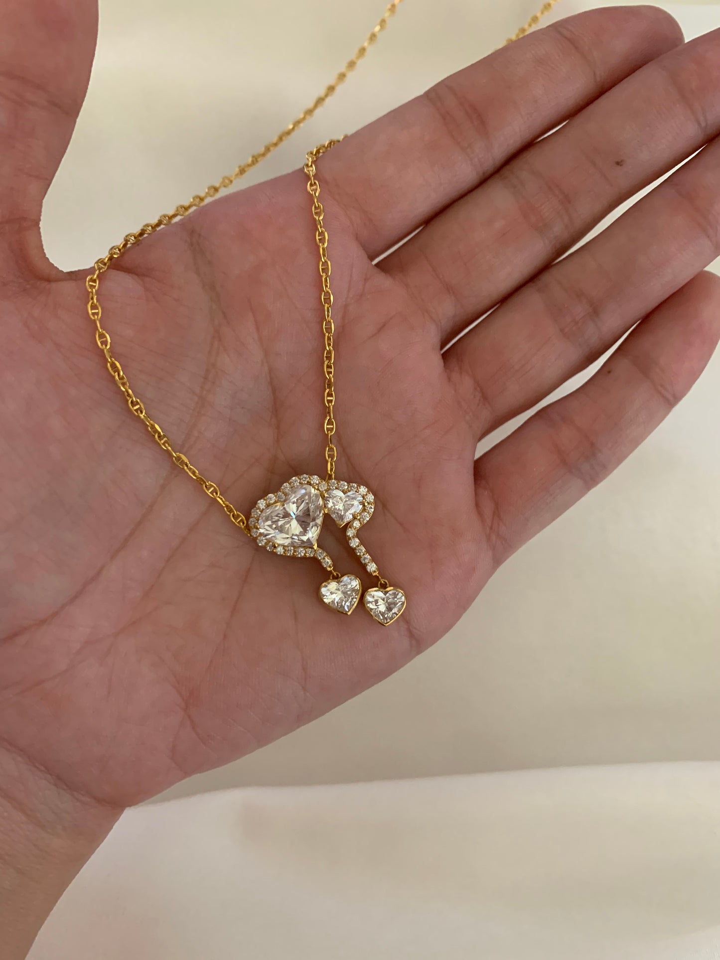 18K gold necklace featuring a 3ct diamond and GIA-certified heart diamonds. Sustainable corporate gift jewelry with abaca packaging. Custom gold-plated necklace, bespoke design in Singapore.