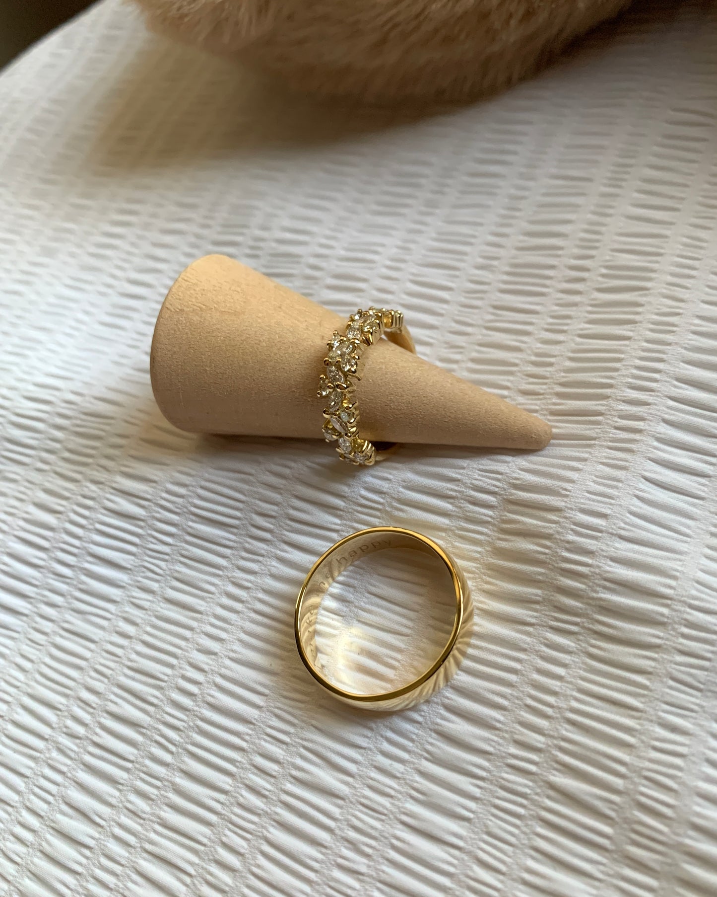 Hers: 12 pieces of pretty marquise-cut diamonds 5mm band. and 11 pieces round natural diamonds in clustered style and in 14k yellow gold band. His: A simple 14k gold