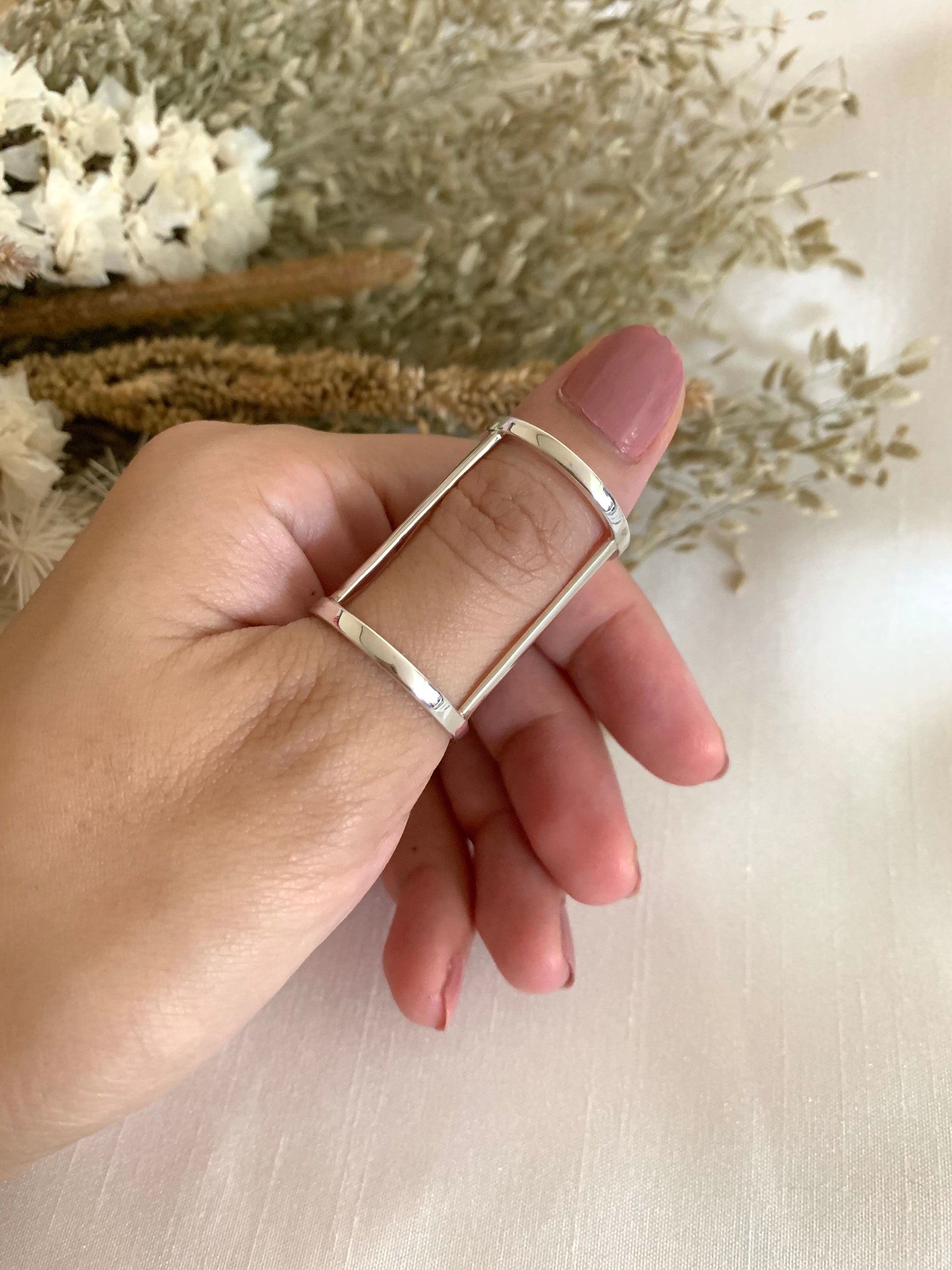 A white gold finger brace which supports the finger/s.