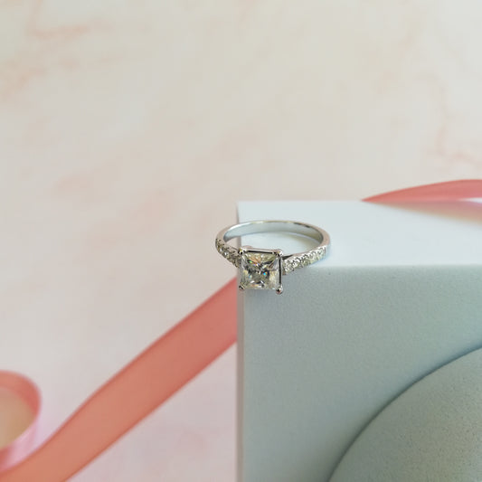 A square diamond ring. The band are with small diamond stones.