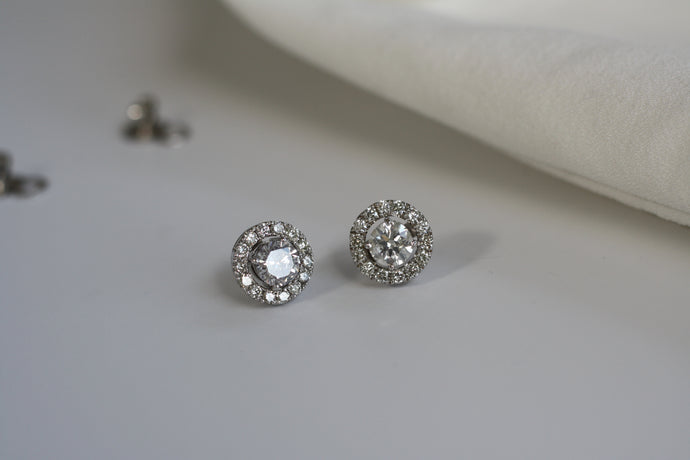 2 round sparkling diamond earrings with halo in white gold setting. 