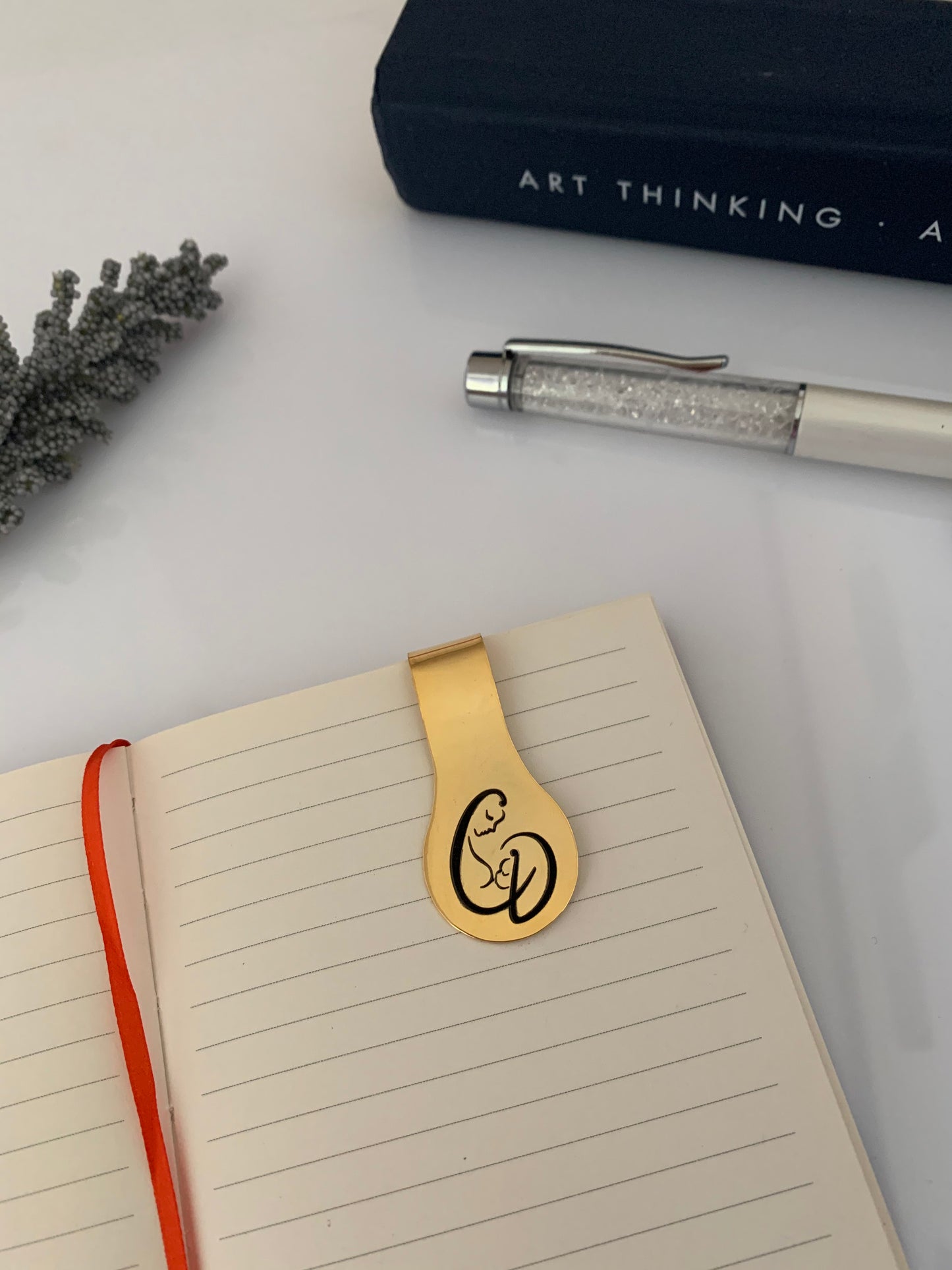 Personalized gold money clip with the images of a mother and her child incorporated with the "C" and "D" initials.