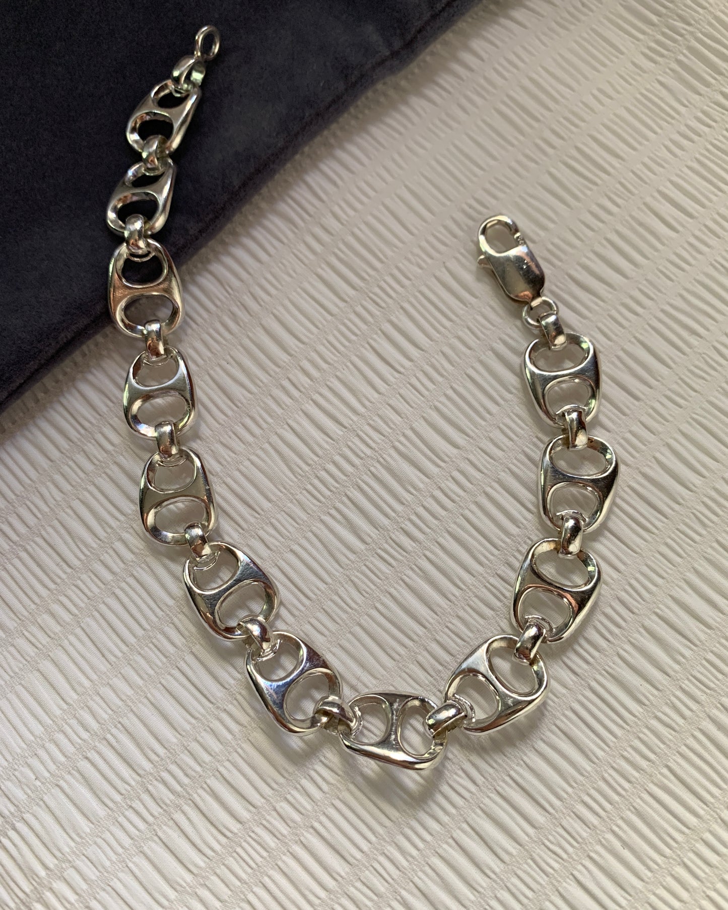 Closely linked silver beer tabs made as an attractive and unique bracelet.