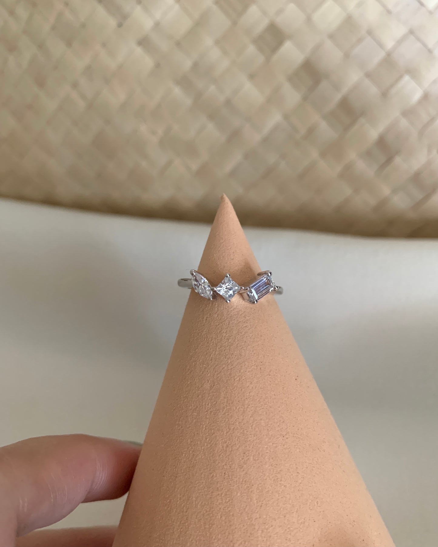 three pieces of signity stones shapes such as marquise, princess cut and emerald. set in white gold.