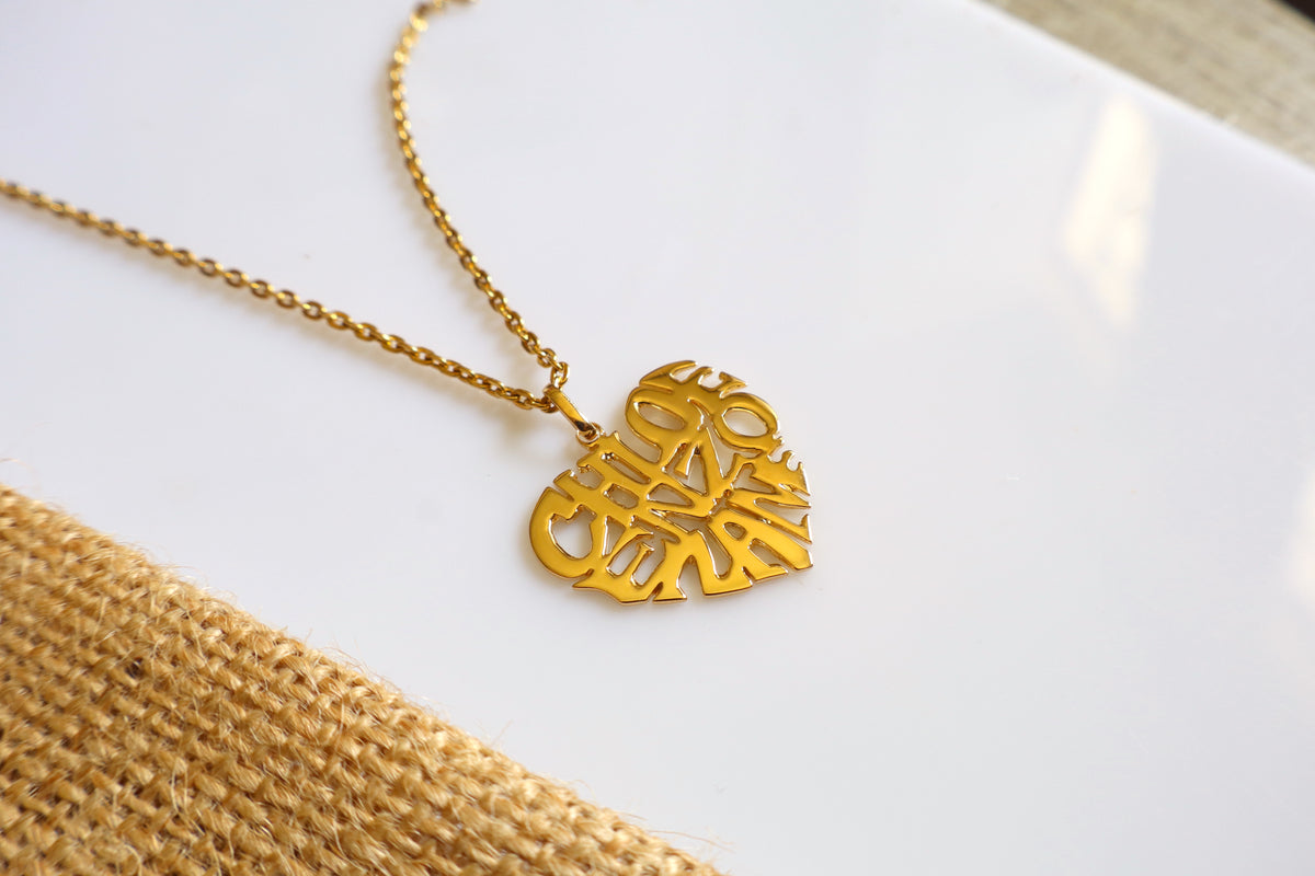 Handmade 14K gold custom heart name necklace with a personalized name cutout pendant, measuring 2.5cm x 2.5cm, displayed on a white surface.