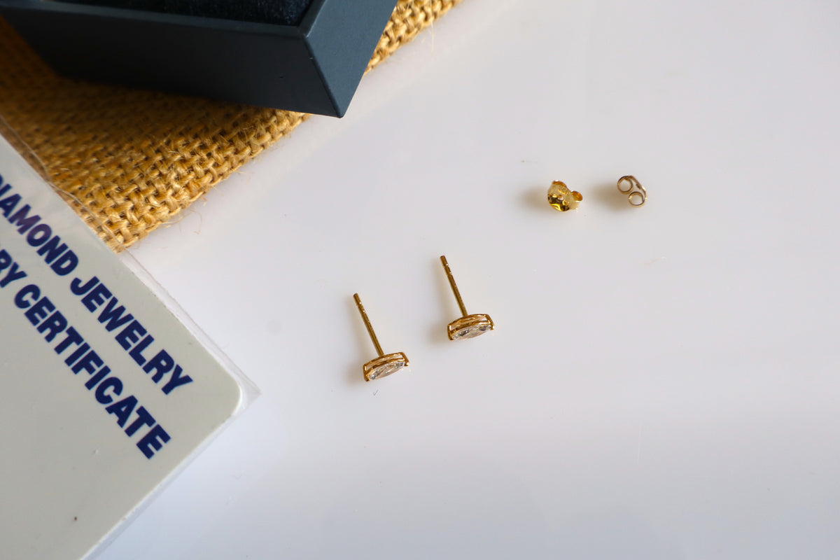 14K gold earrings featuring lab-grown marquise diamonds in a minimalist design.