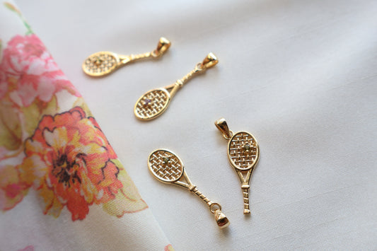 Custom 18K yellow gold birthstone pendant crafted to symbolize friendship and shared passion, eco-friendly corporate gift jewelry in abaca packaging, bespoke design for Singapore companies.