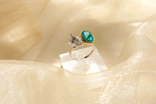 18K white gold ring featuring a pear-shaped lab-grown diamond and natural emerald, presented in eco-friendly packaging for a Singapore corporate