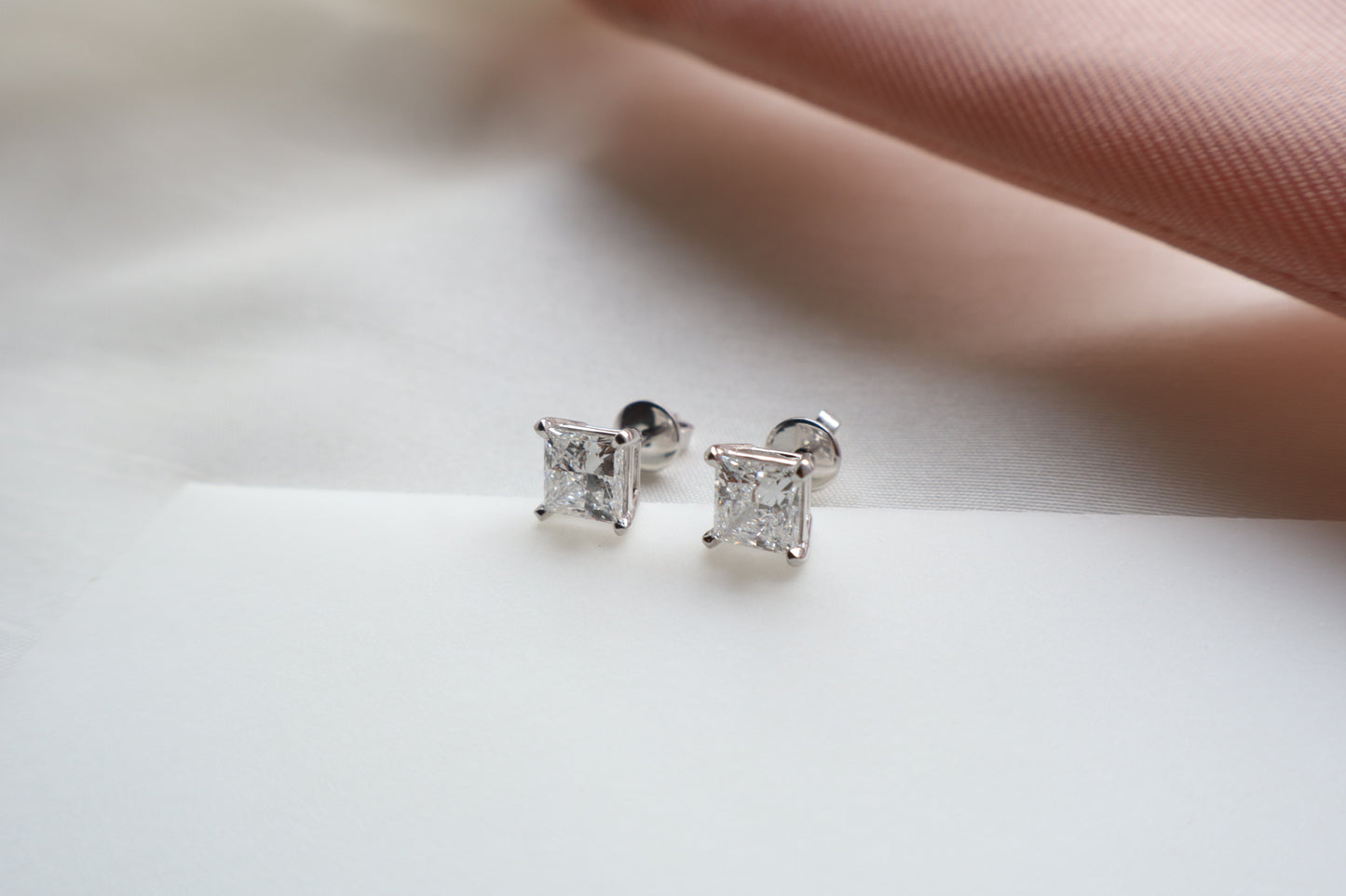 Elegant 14K white gold diamond stud earrings featuring 1.5-carat diamonds each, custom-crafted for timeless everyday wear, presented in eco-friendly packaging for Singapore corporate gifting.