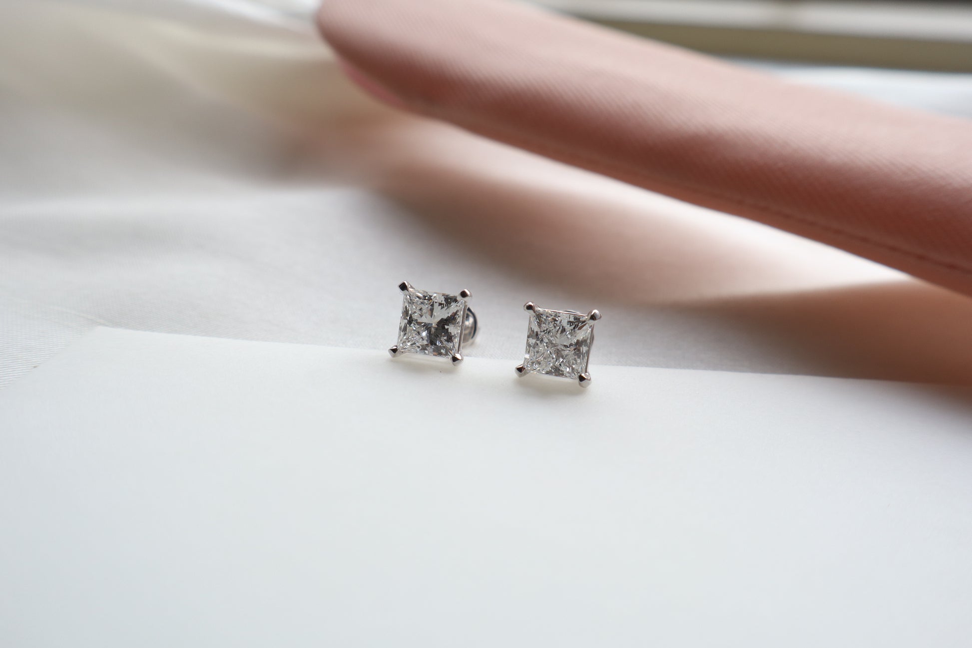 Elegant 14K white gold diamond stud earrings featuring 1.5-carat diamonds each, custom-crafted for timeless everyday wear, presented in eco-friendly packaging for Singapore corporate gifting.
