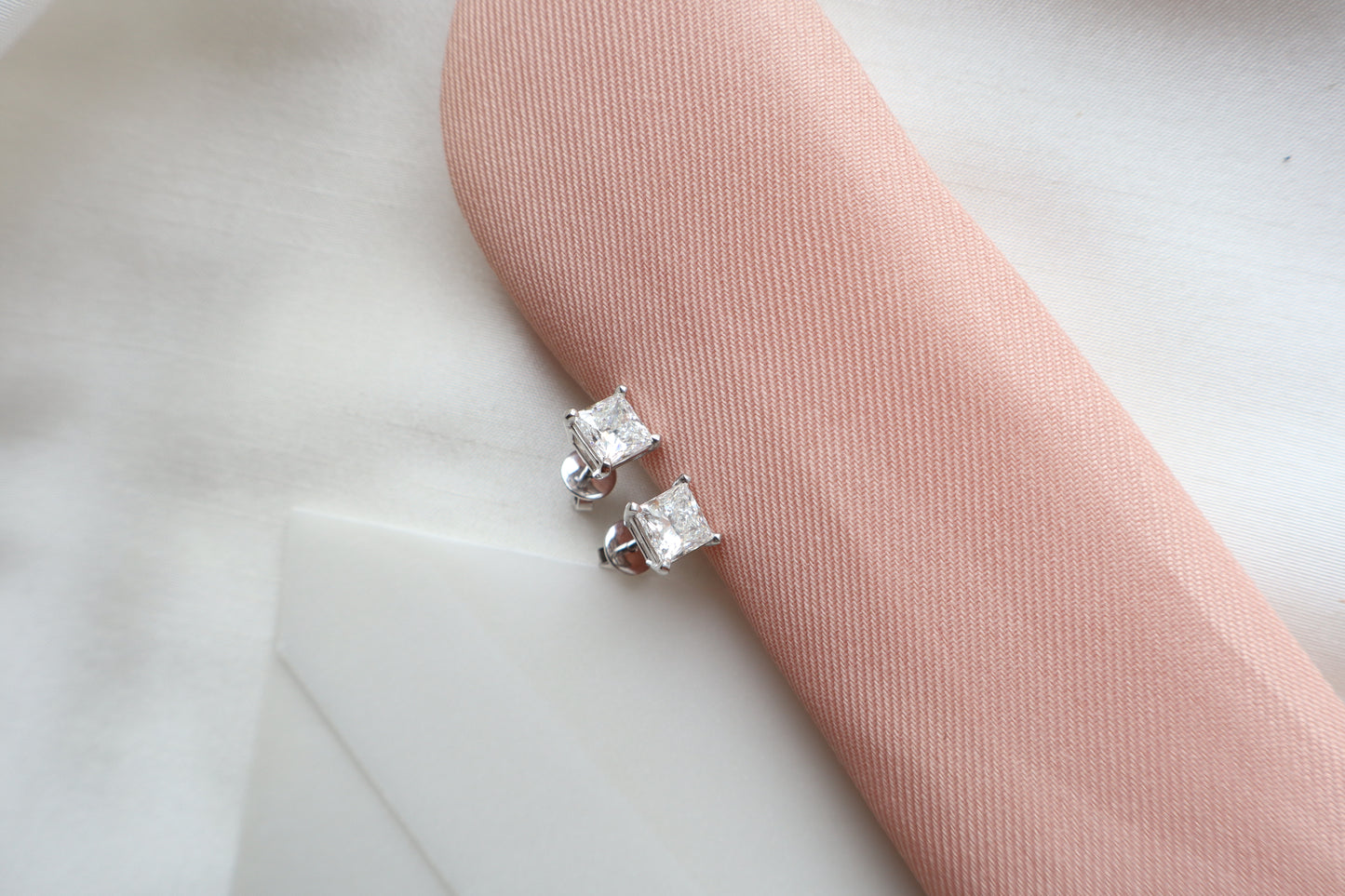 Elegant 14K white gold diamond stud earrings featuring 1.5-carat diamonds each, custom-crafted for timeless everyday wear, presented in eco-friendly packaging for Singapore corporate gifting.