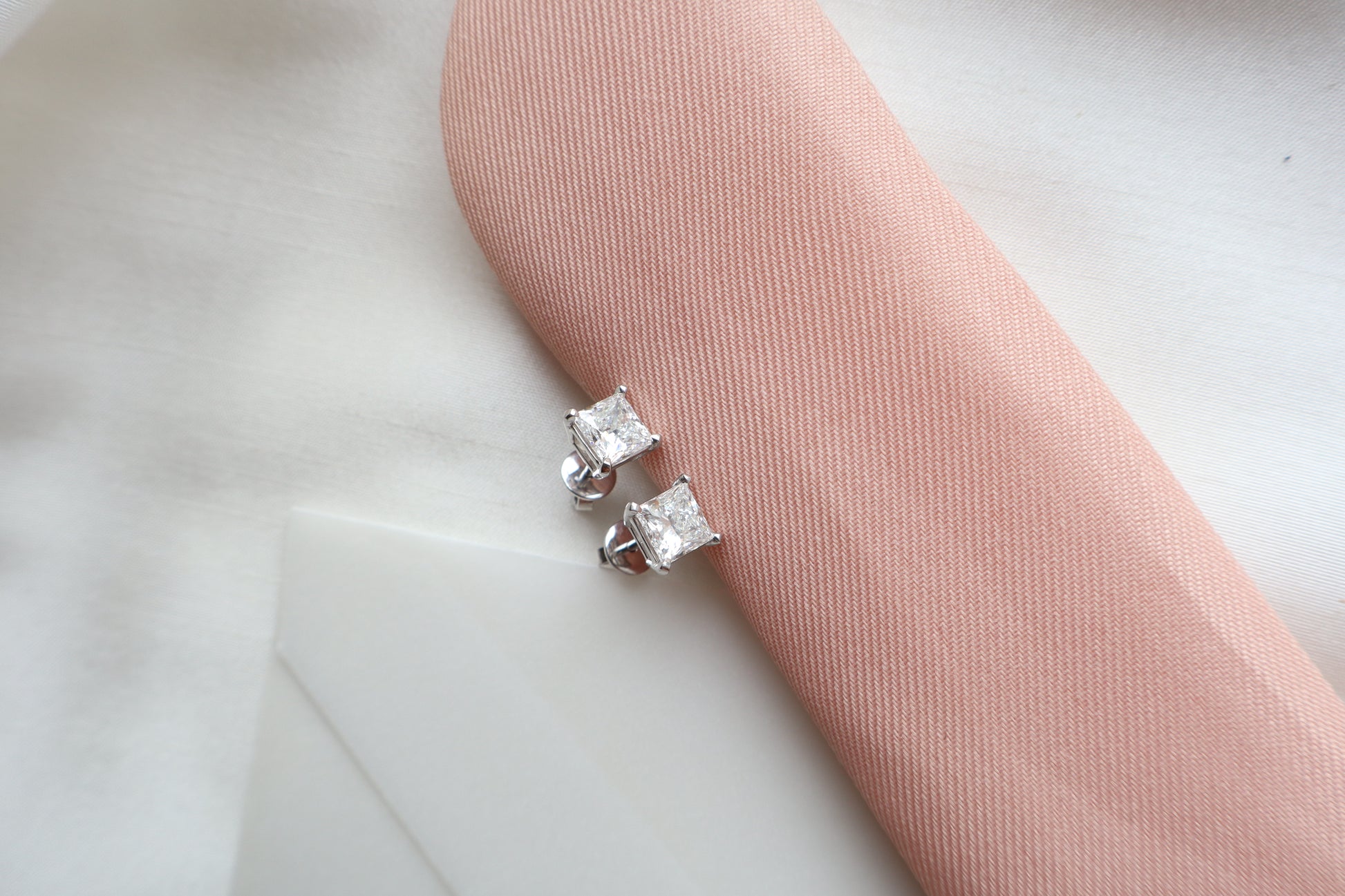 Elegant 14K white gold diamond stud earrings featuring 1.5-carat diamonds each, custom-crafted for timeless everyday wear, presented in eco-friendly packaging for Singapore corporate gifting.