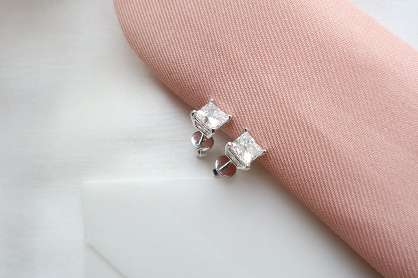 Elegant 14K white gold diamond stud earrings featuring 1.5-carat diamonds each, custom-crafted for timeless everyday wear, presented in eco-friendly packaging for Singapore corporate gifting.
