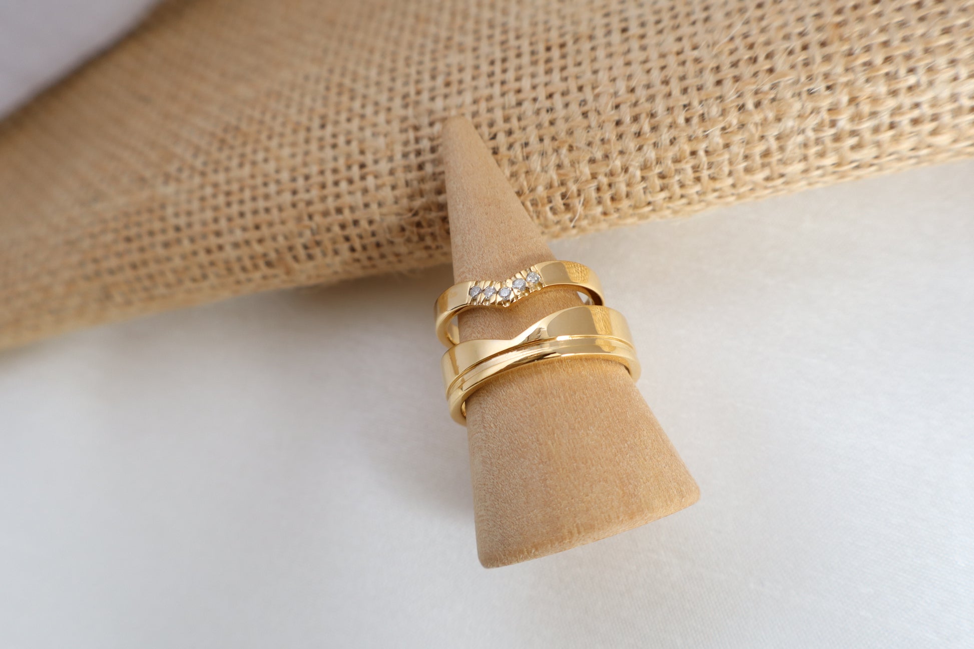 Luxury 14kt gold wedding ring set, women's 5-diamond band and men's 6mm ring. Packaged in sustainable jewelry boxes, ideal for corporate service awards in SG.