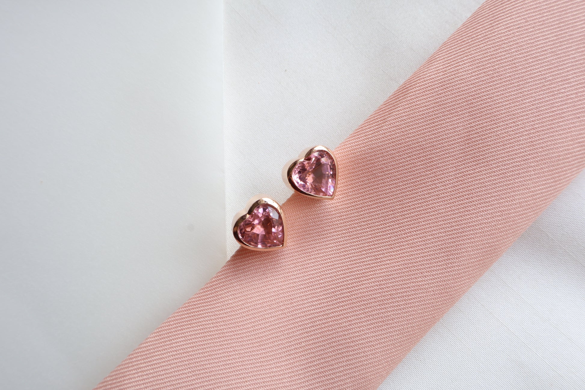 18K rose gold heart-shaped stud earrings with natural pink sapphires (2.64 carats each, 10mm) — Singapore bespoke corporate jewelry, business milestone gift, custom luxury gemstone piece.