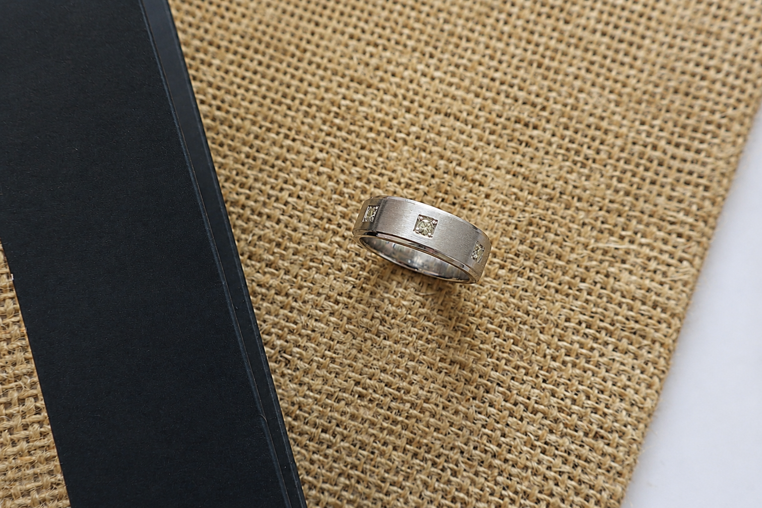 Handcrafted Platinum 950 ring featuring three natural diamonds in a modern brushed design. Ideal example of custom jewelry craftsmanship for corporate awards, service pins, and premium gifting.