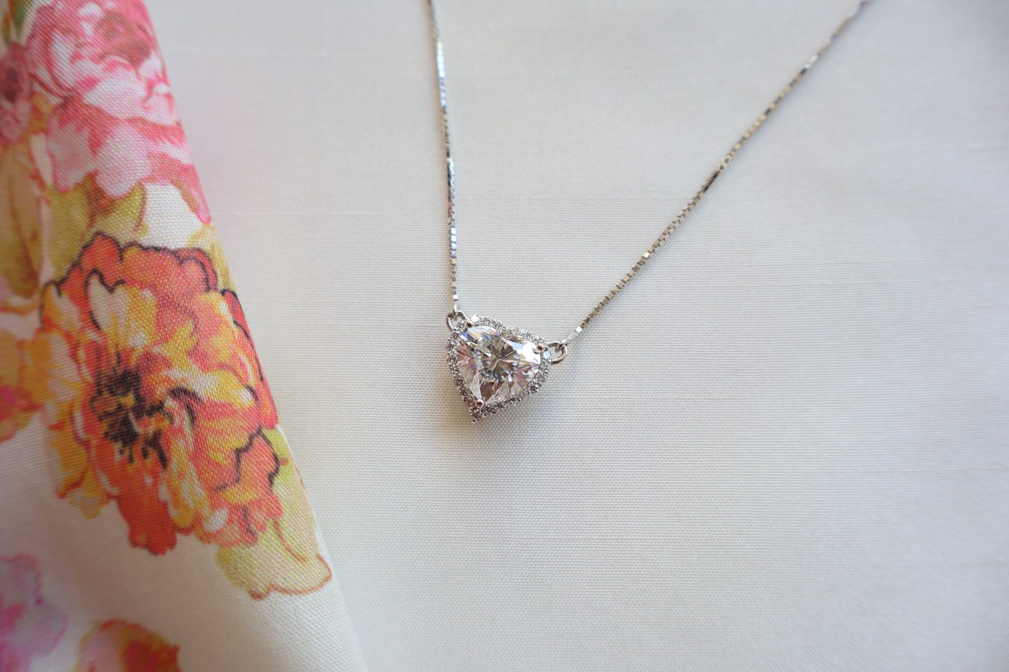 Heart-shaped 3 carat lab diamond halo pendant necklace on a fine chain — Eco-luxury abaca packaging with bespoke corporate recognition jewelry, customized design.