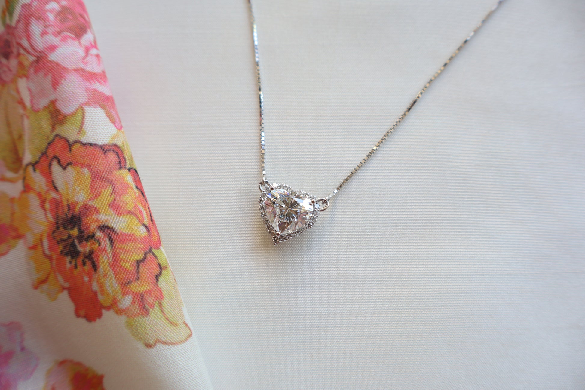 Heart-shaped 3 carat lab diamond halo pendant necklace on a fine chain — Eco-luxury abaca packaging with bespoke corporate recognition jewelry, customized design.
