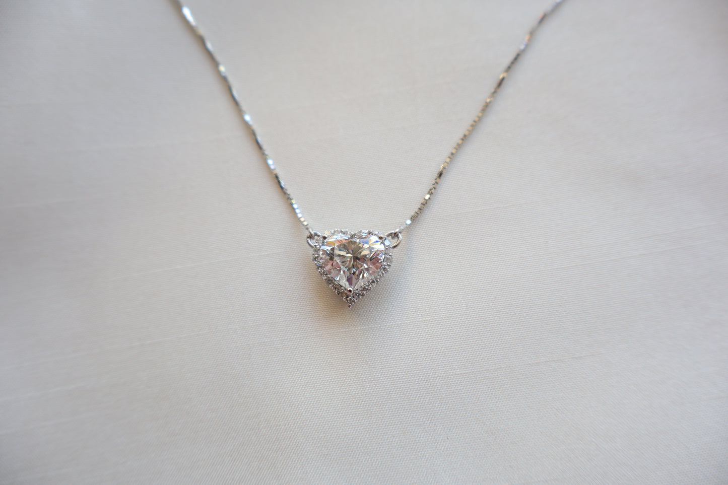 Heart-shaped 3 carat lab diamond halo pendant necklace on a fine chain — Eco-luxury abaca packaging with bespoke corporate recognition jewelry, customized design.