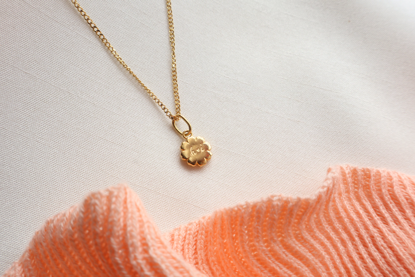 Dainty 8mm 14K Gold Floral Pendant. Premium eco-friendly corporate gift jewelry in abaca packaging for bespoke employee recognition in Singapore