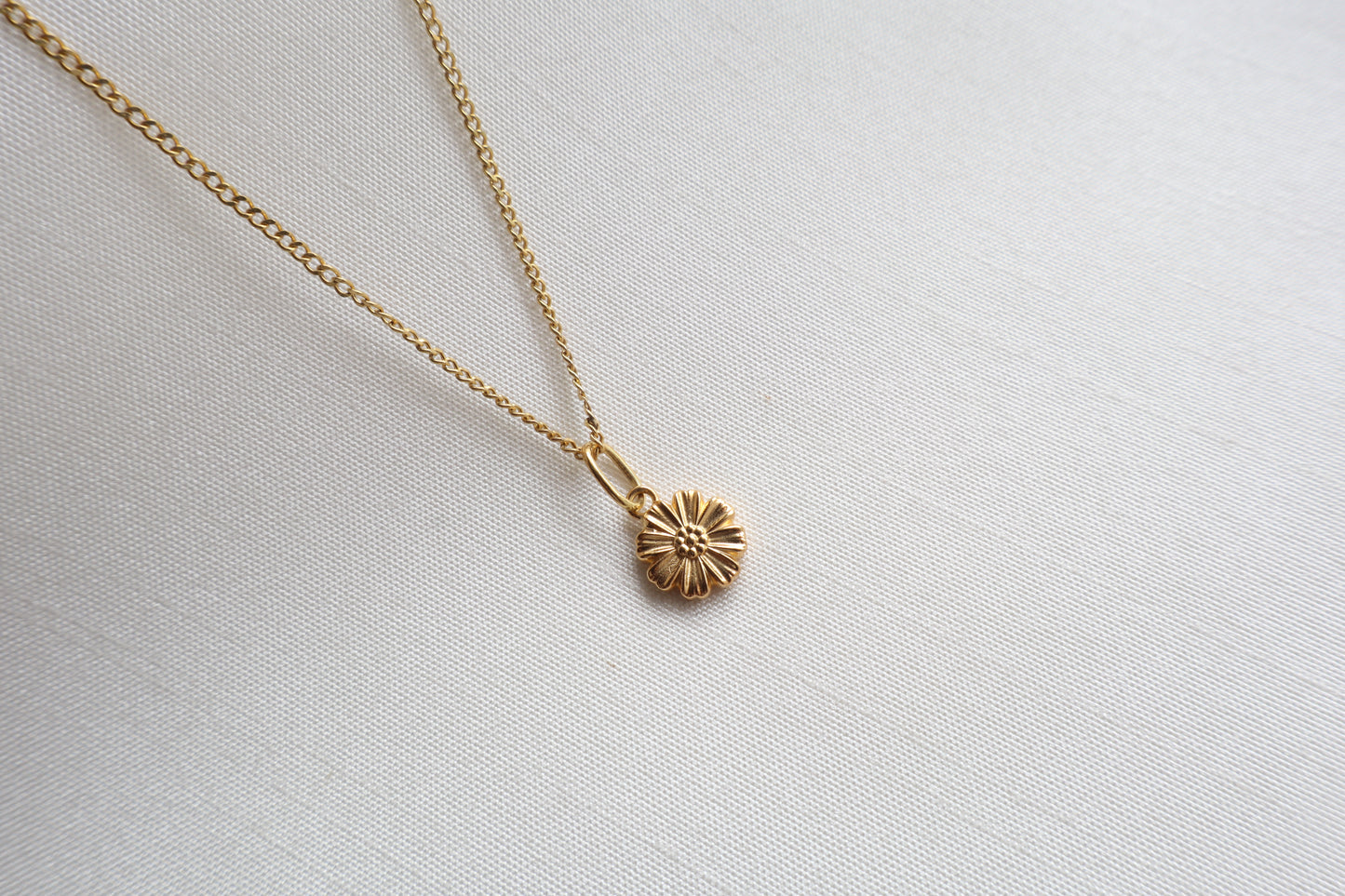Dainty 8mm 14K Gold Floral Pendant. Premium eco-friendly corporate gift jewelry in abaca packaging for bespoke employee recognition in Singapore