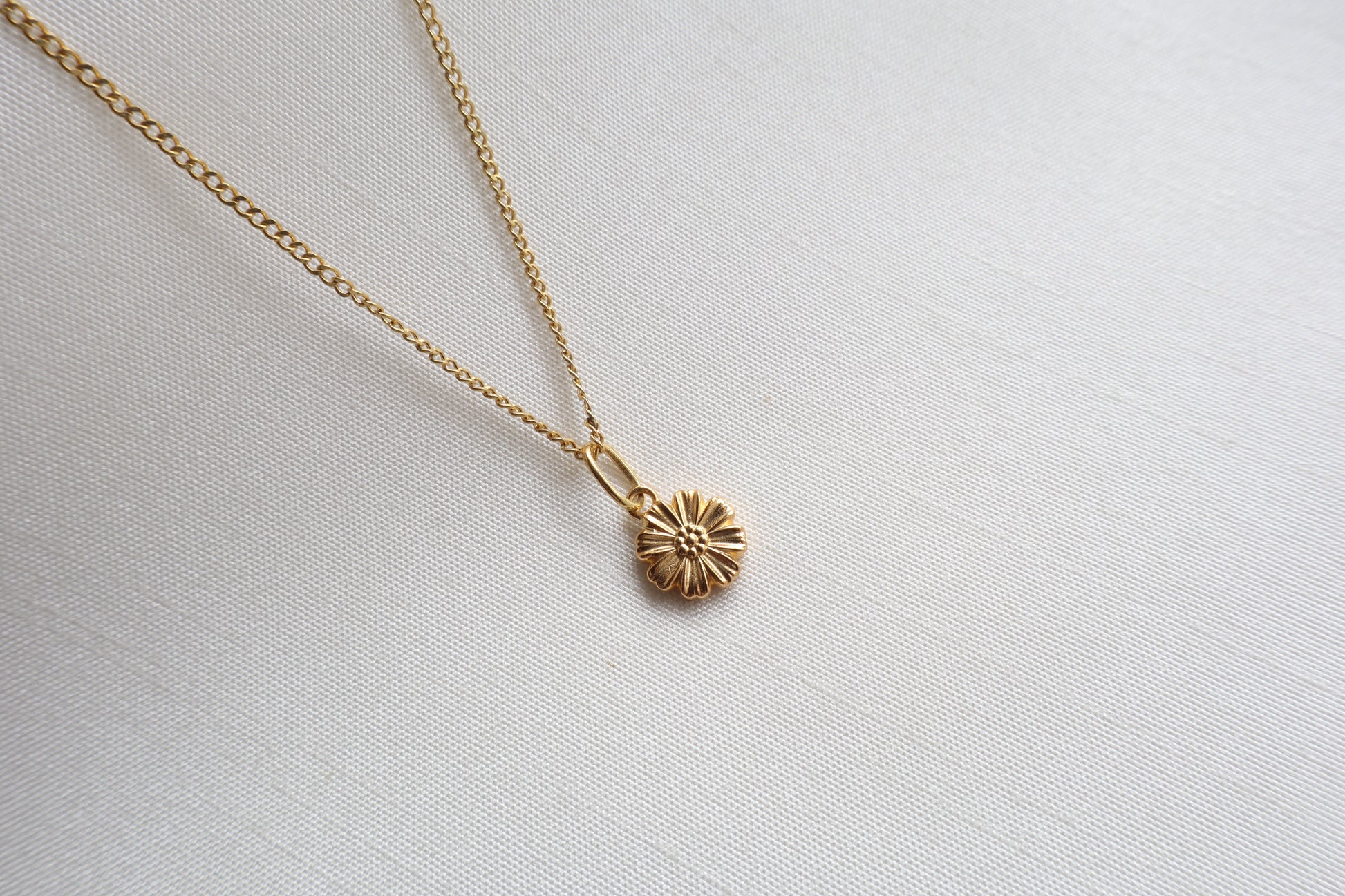 Dainty 8mm 14K Gold Floral Pendant. Premium eco-friendly corporate gift jewelry in abaca packaging for bespoke employee recognition in Singapore