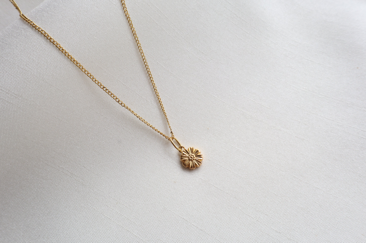 Dainty 8mm 14K Gold Floral Pendant. Premium eco-friendly corporate gift jewelry in abaca packaging for bespoke employee recognition in Singapore