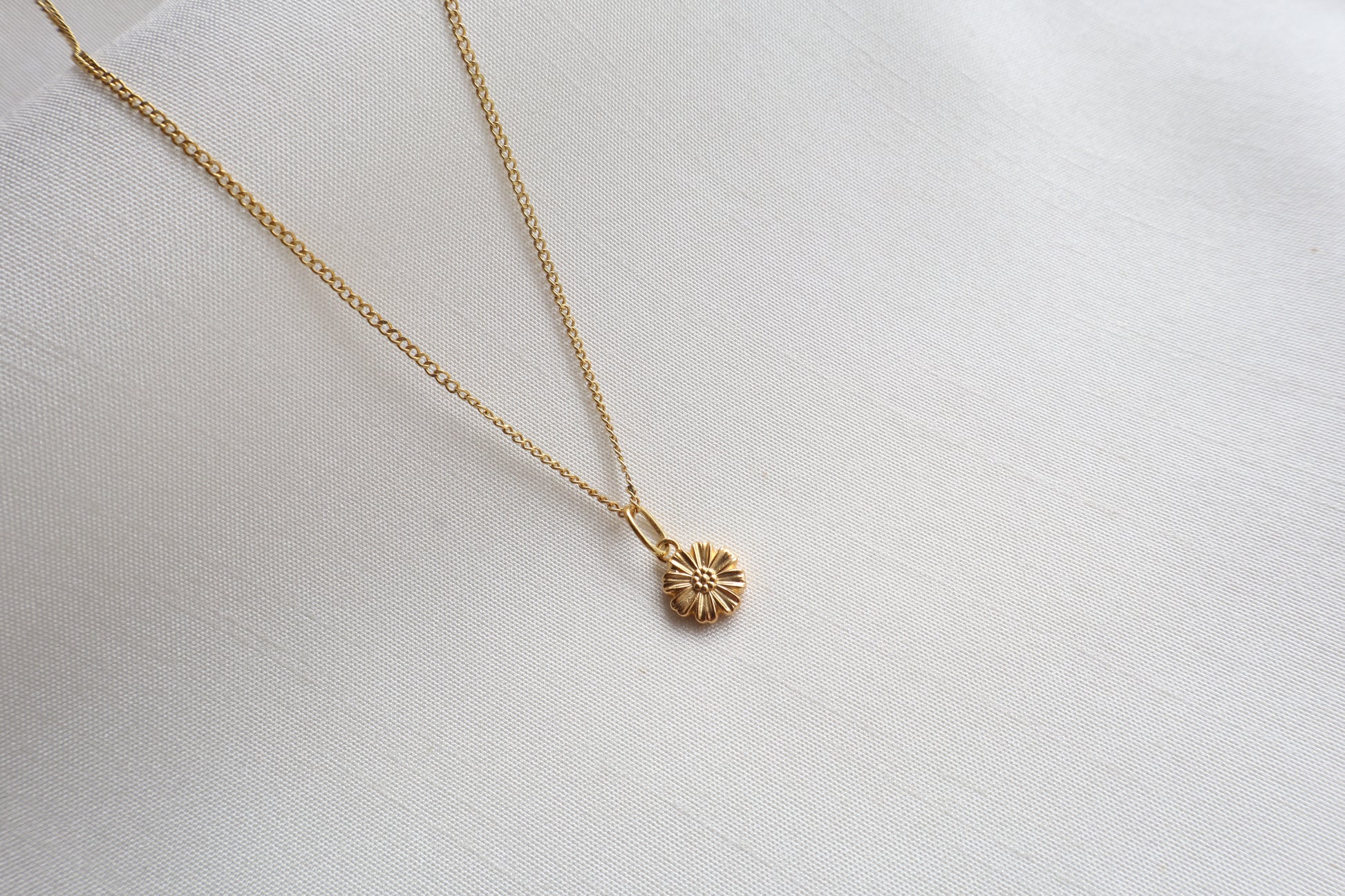 Dainty 8mm 14K Gold Floral Pendant. Premium eco-friendly corporate gift jewelry in abaca packaging for bespoke employee recognition in Singapore