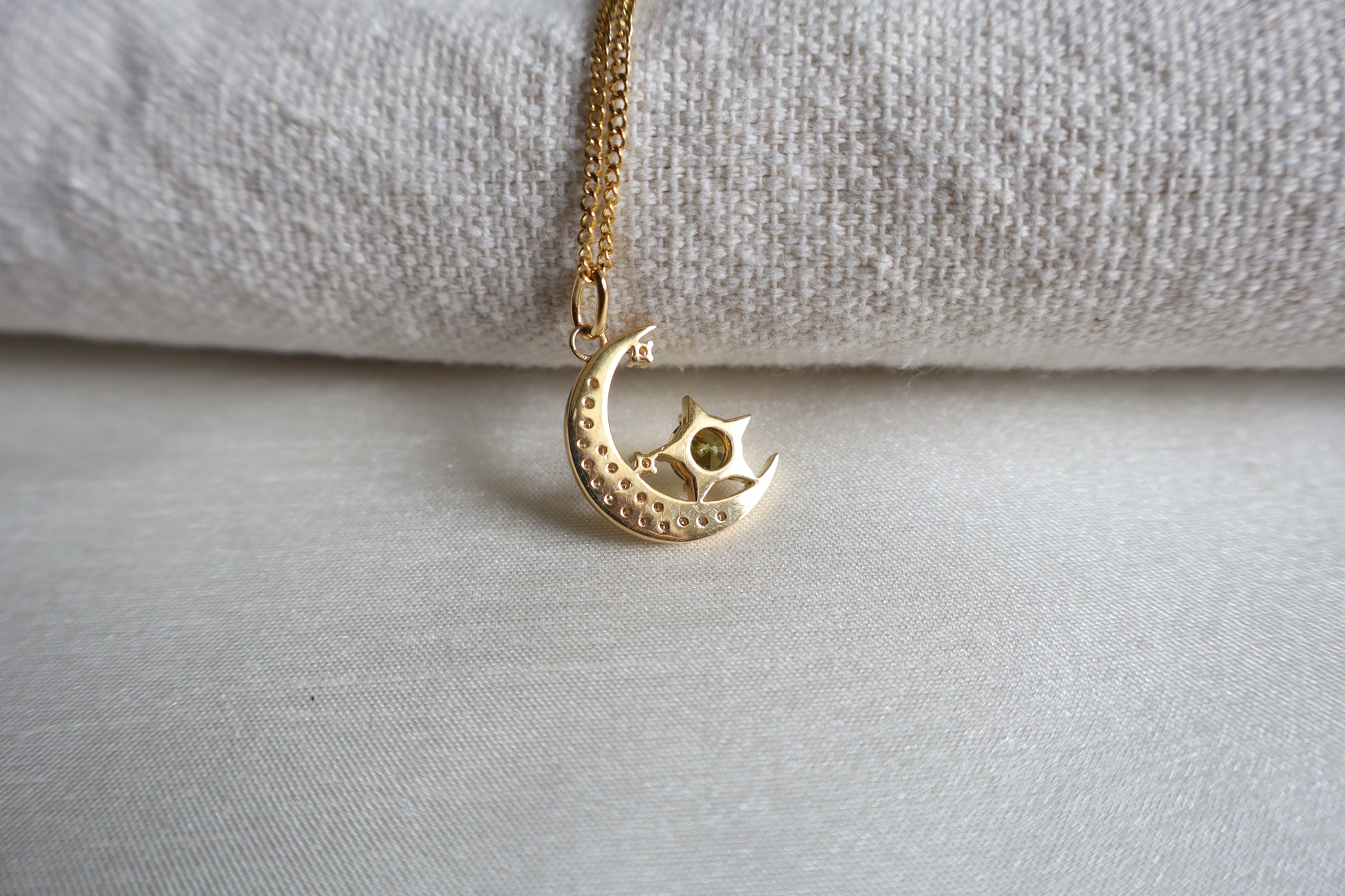14-Karat Gold crescent moon pendant with peridot star and diamond accents. Designed in Singapore with luxury packaging, perfect for corporate gifts and client milestones.
