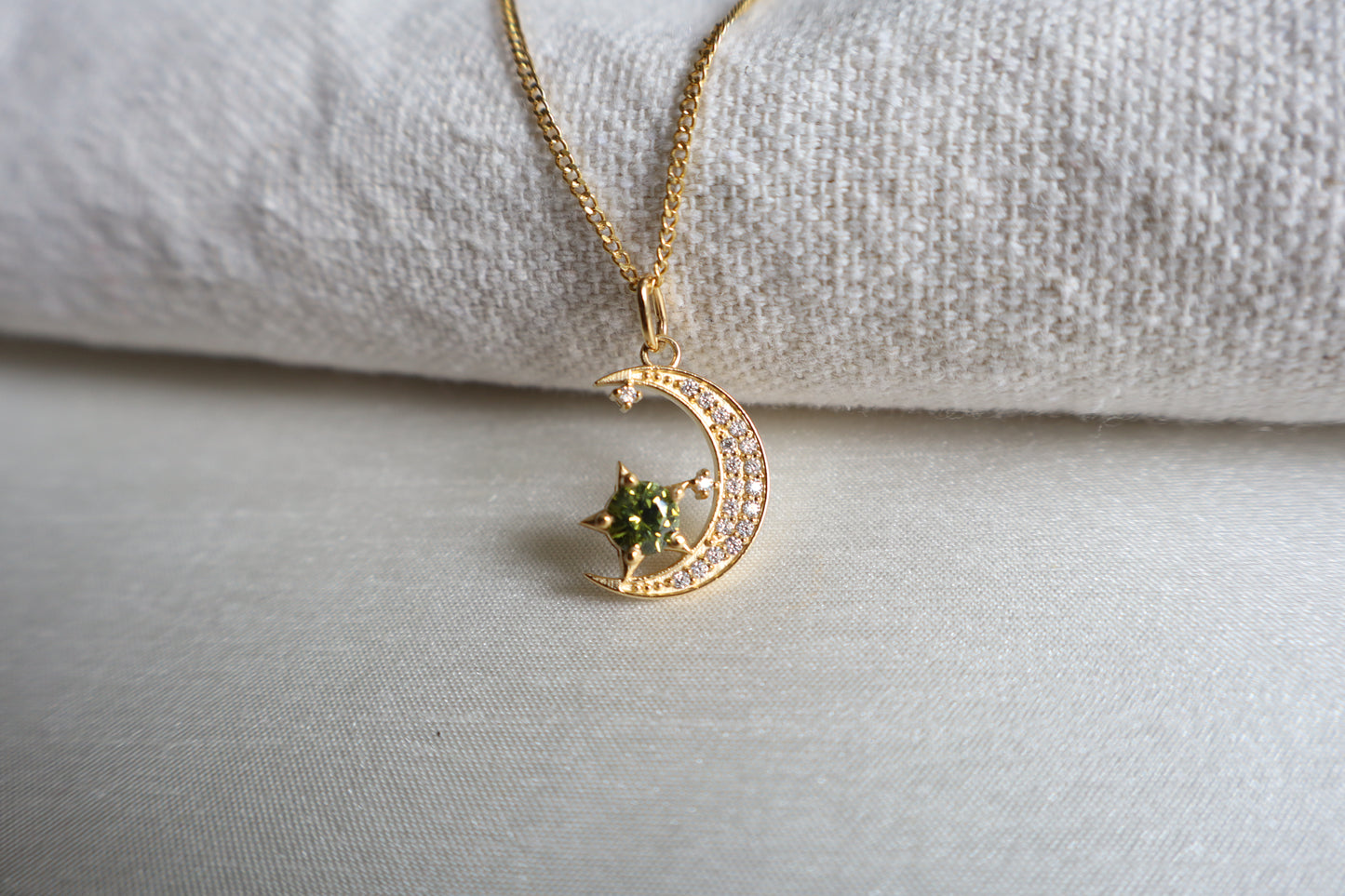14-Karat Gold crescent moon pendant with peridot star and diamond accents. Designed in Singapore with luxury packaging, perfect for corporate gifts and client milestones.