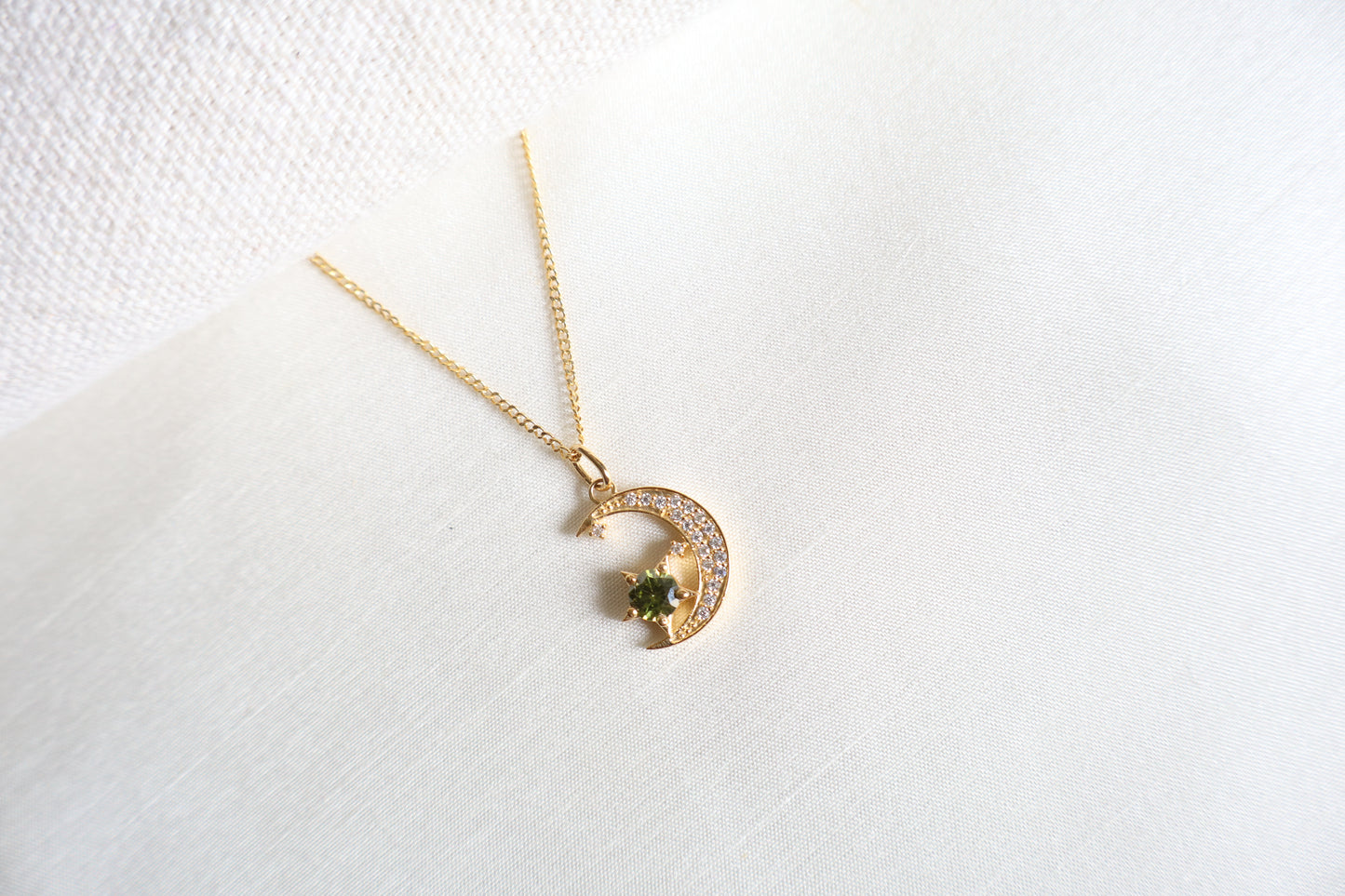 14-Karat Gold crescent moon pendant with peridot star and diamond accents. Designed in Singapore with luxury packaging, perfect for corporate gifts and client milestones.