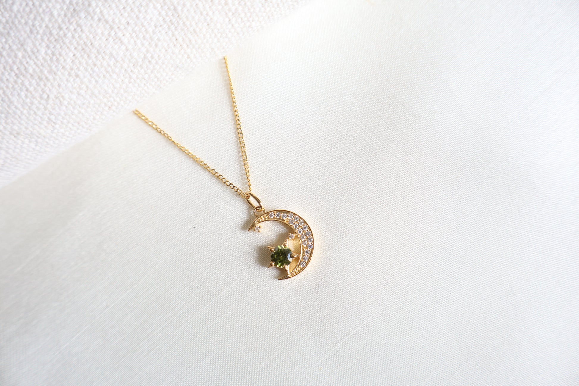 14-Karat Gold crescent moon pendant with peridot star and diamond accents. Designed in Singapore with luxury packaging, perfect for corporate gifts and client milestones.
