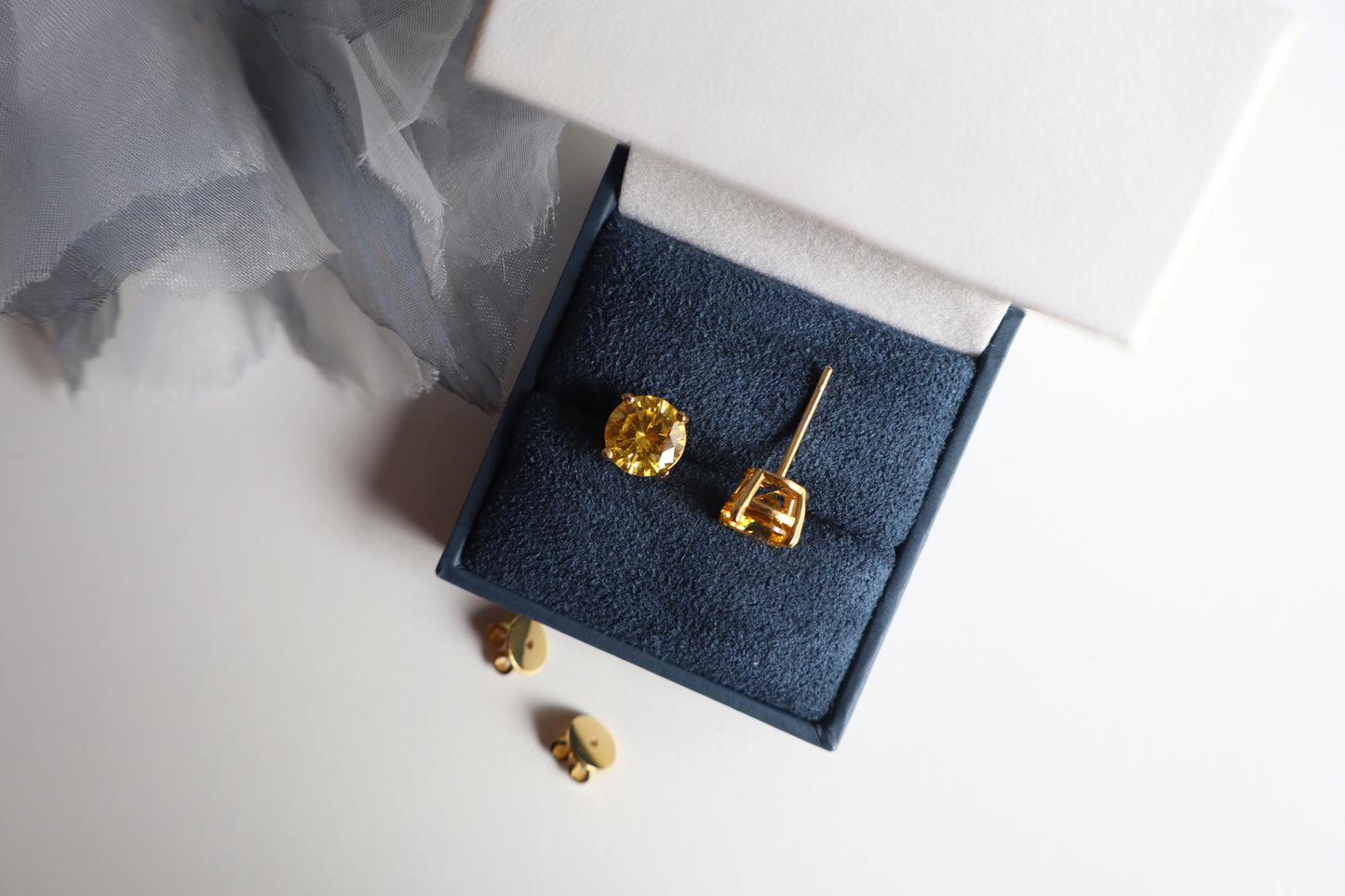 14-karat gold stud earrings featuring 8mm round citrine gemstones, elegantly presented in eco-friendly packaging. Designed in Singapore for timeless sophistication.
