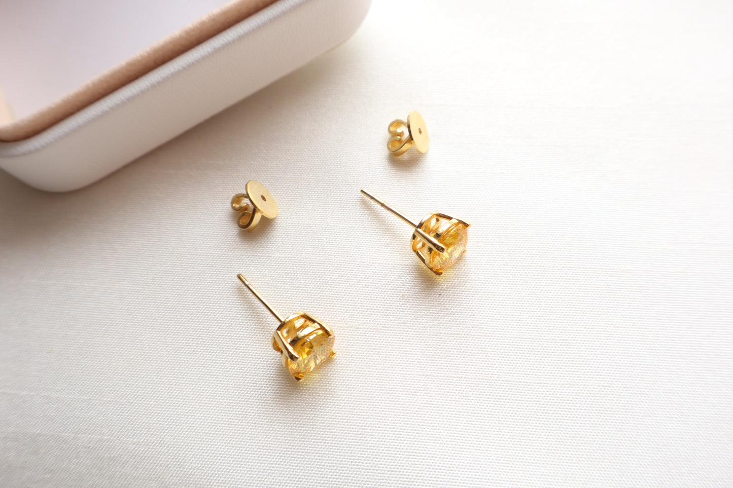 14-karat gold stud earrings featuring 8mm round citrine gemstones, elegantly presented in eco-friendly packaging. Designed in Singapore for timeless sophistication.