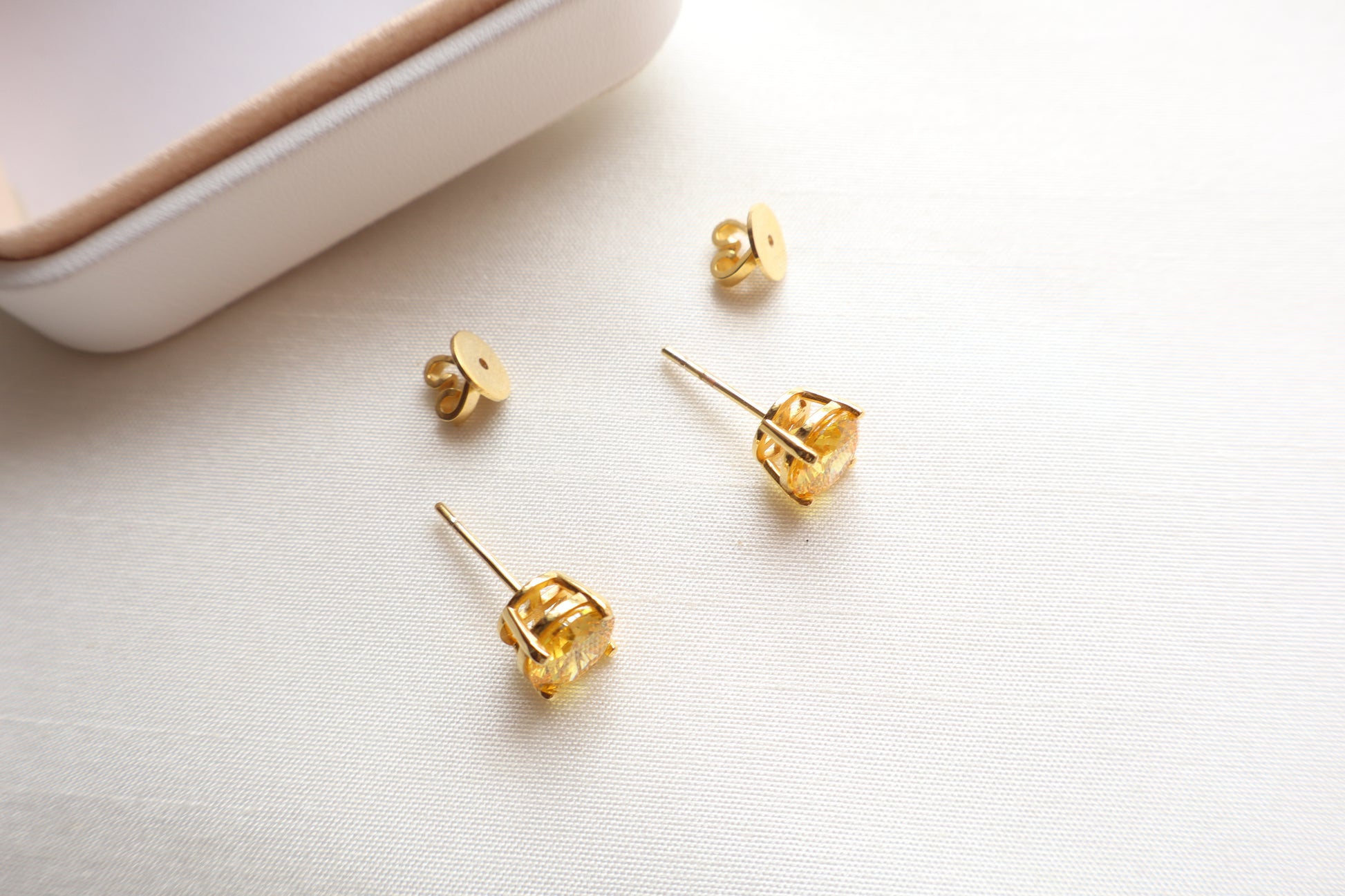 14-karat gold stud earrings featuring 8mm round citrine gemstones, elegantly presented in eco-friendly packaging. Designed in Singapore for timeless sophistication.