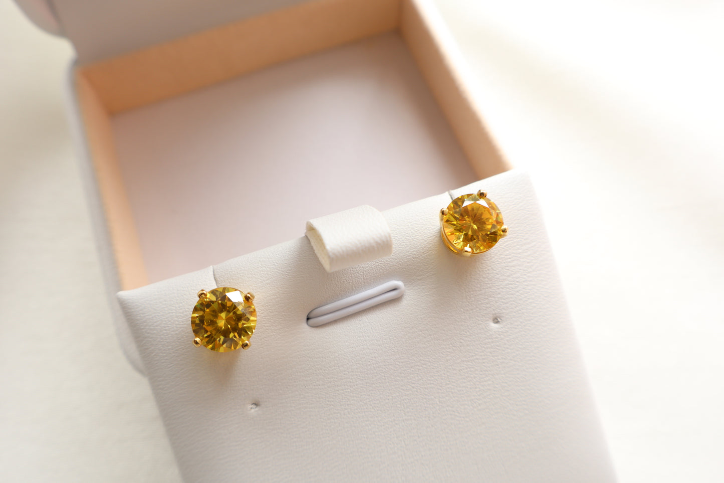 14-karat gold stud earrings featuring 8mm round citrine gemstones, elegantly presented in eco-friendly packaging. Designed in Singapore for timeless sophistication.