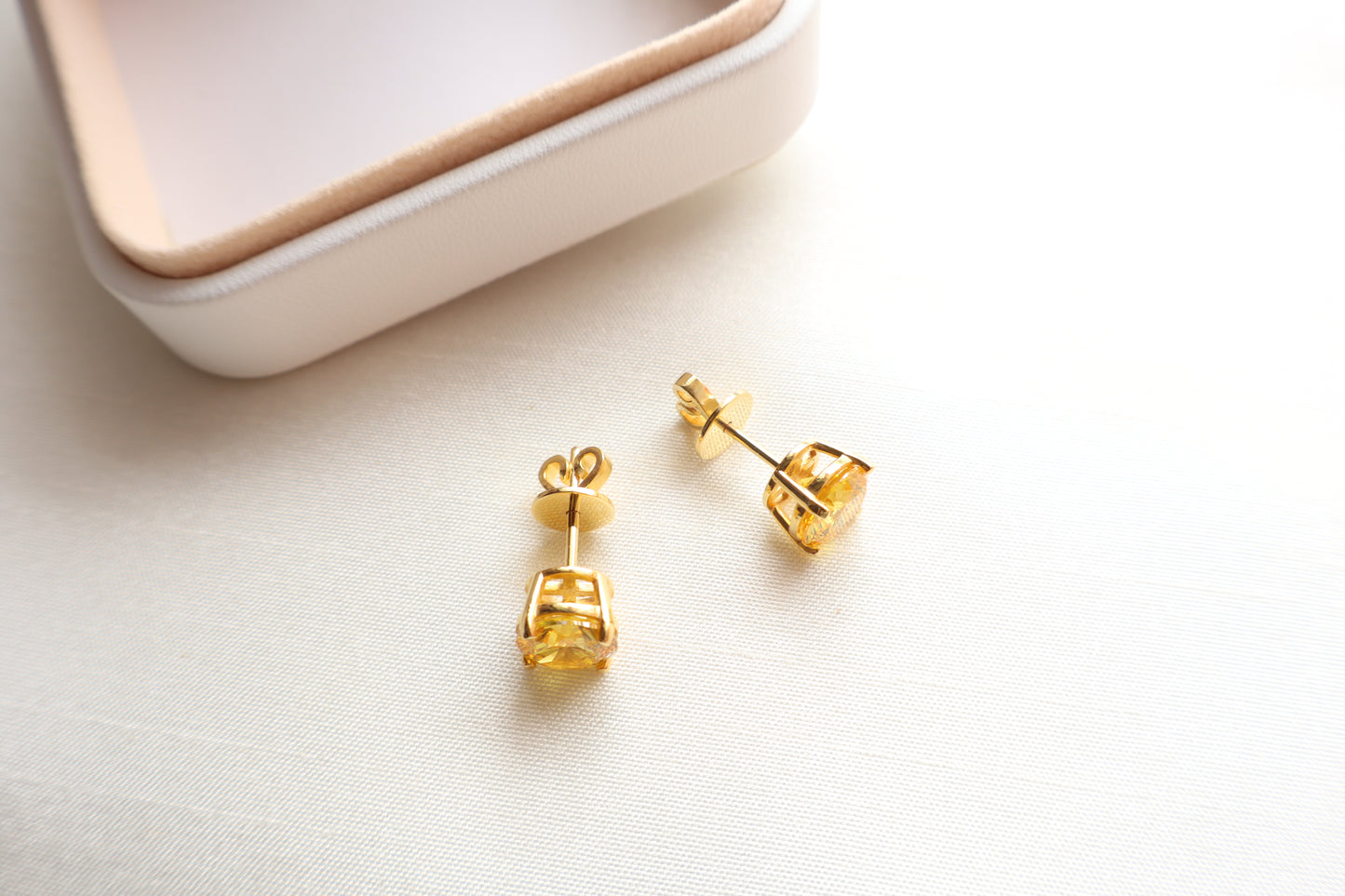 14-karat gold stud earrings featuring 8mm round citrine gemstones, elegantly presented in eco-friendly packaging. Designed in Singapore for timeless sophistication.