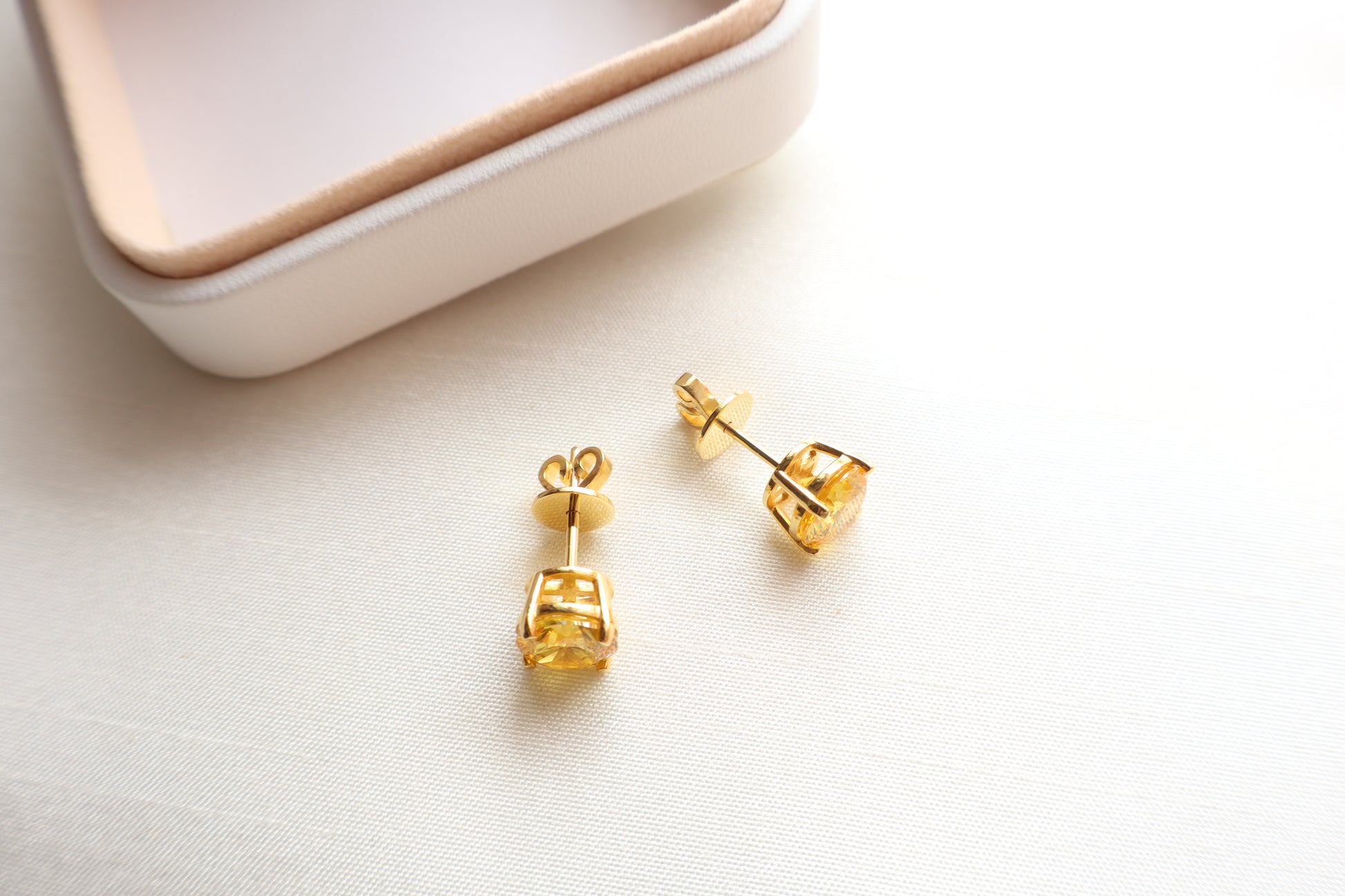 14-karat gold stud earrings featuring 8mm round citrine gemstones, elegantly presented in eco-friendly packaging. Designed in Singapore for timeless sophistication.
