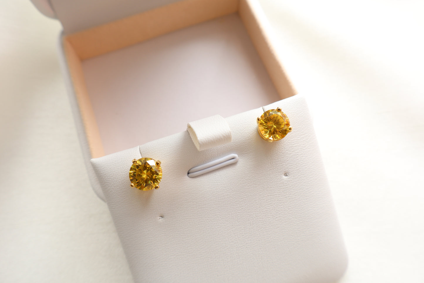 14-karat gold stud earrings featuring 8mm round citrine gemstones, elegantly presented in eco-friendly packaging. Designed in Singapore for timeless sophistication.