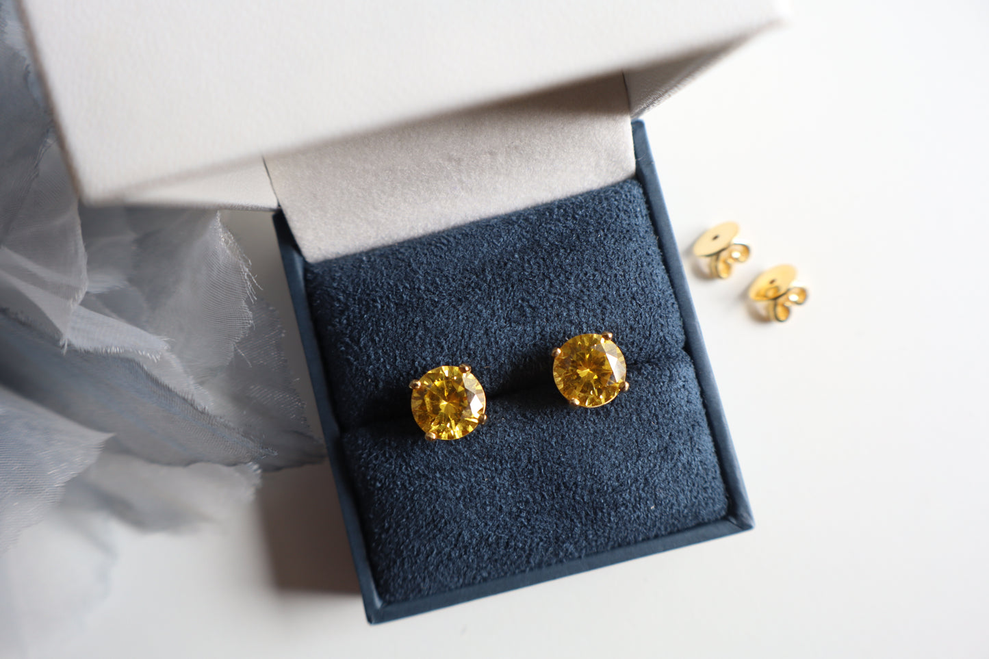 14-karat gold stud earrings featuring 8mm round citrine gemstones, elegantly presented in eco-friendly packaging. Designed in Singapore for timeless sophistication.