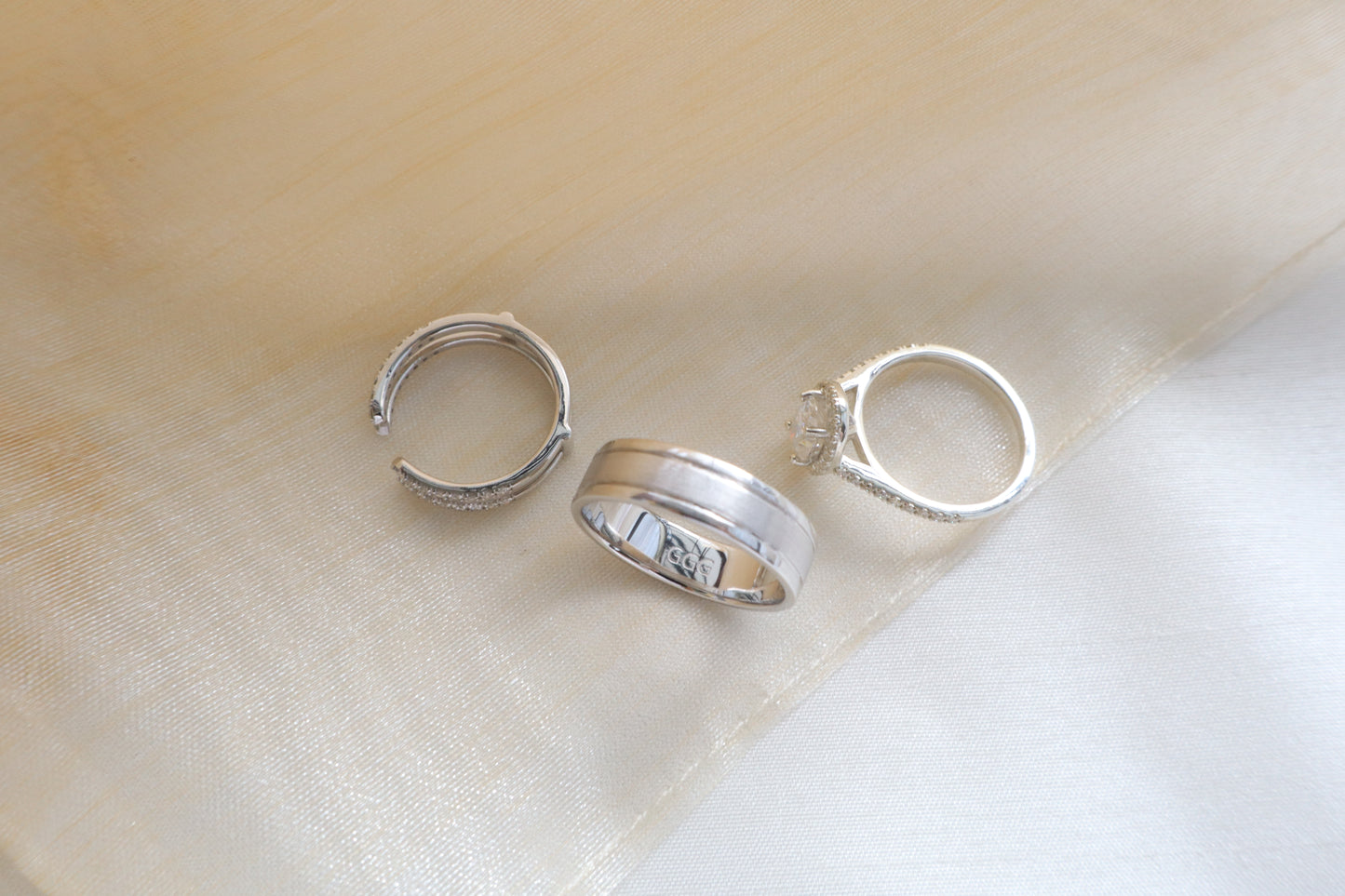 Custom gold bridal ring set with a moissanite engagement ring, diamond wedding band, and engraved groom’s ring, designed as a cohesive family heirloom. Eco-friendly abaca packaging. Singapore corporate jewelry.