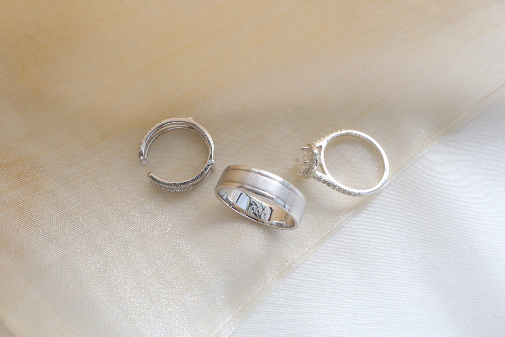 Custom gold bridal ring set with a moissanite engagement ring, diamond wedding band, and engraved groom’s ring, designed as a cohesive family heirloom. Eco-friendly abaca packaging. Singapore corporate jewelry.