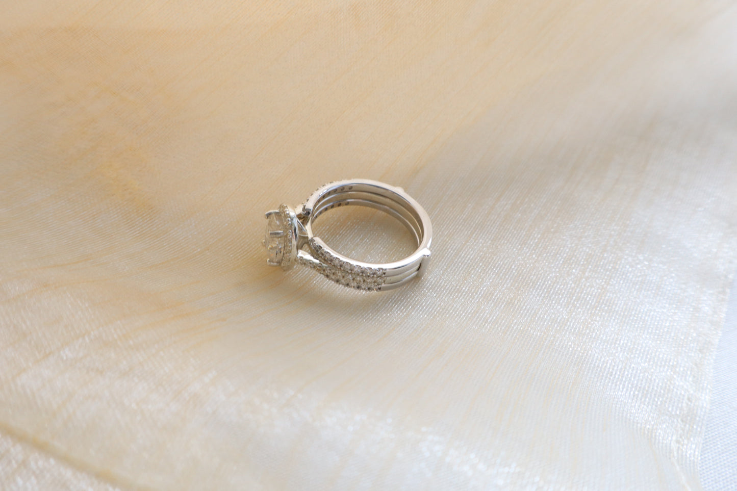 Custom gold bridal ring set with a moissanite engagement ring, diamond wedding band, and engraved groom’s ring, designed as a cohesive family heirloom. Eco-friendly abaca packaging. Singapore corporate jewelry.