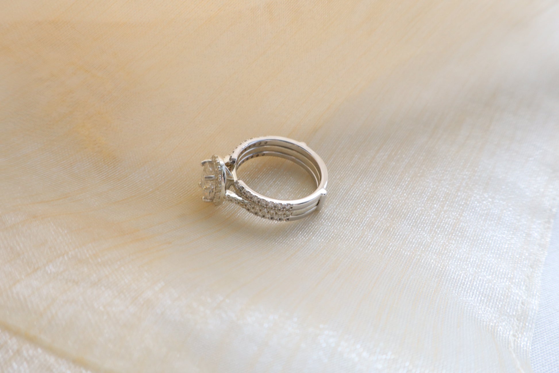Custom gold bridal ring set with a moissanite engagement ring, diamond wedding band, and engraved groom’s ring, designed as a cohesive family heirloom. Eco-friendly abaca packaging. Singapore corporate jewelry.